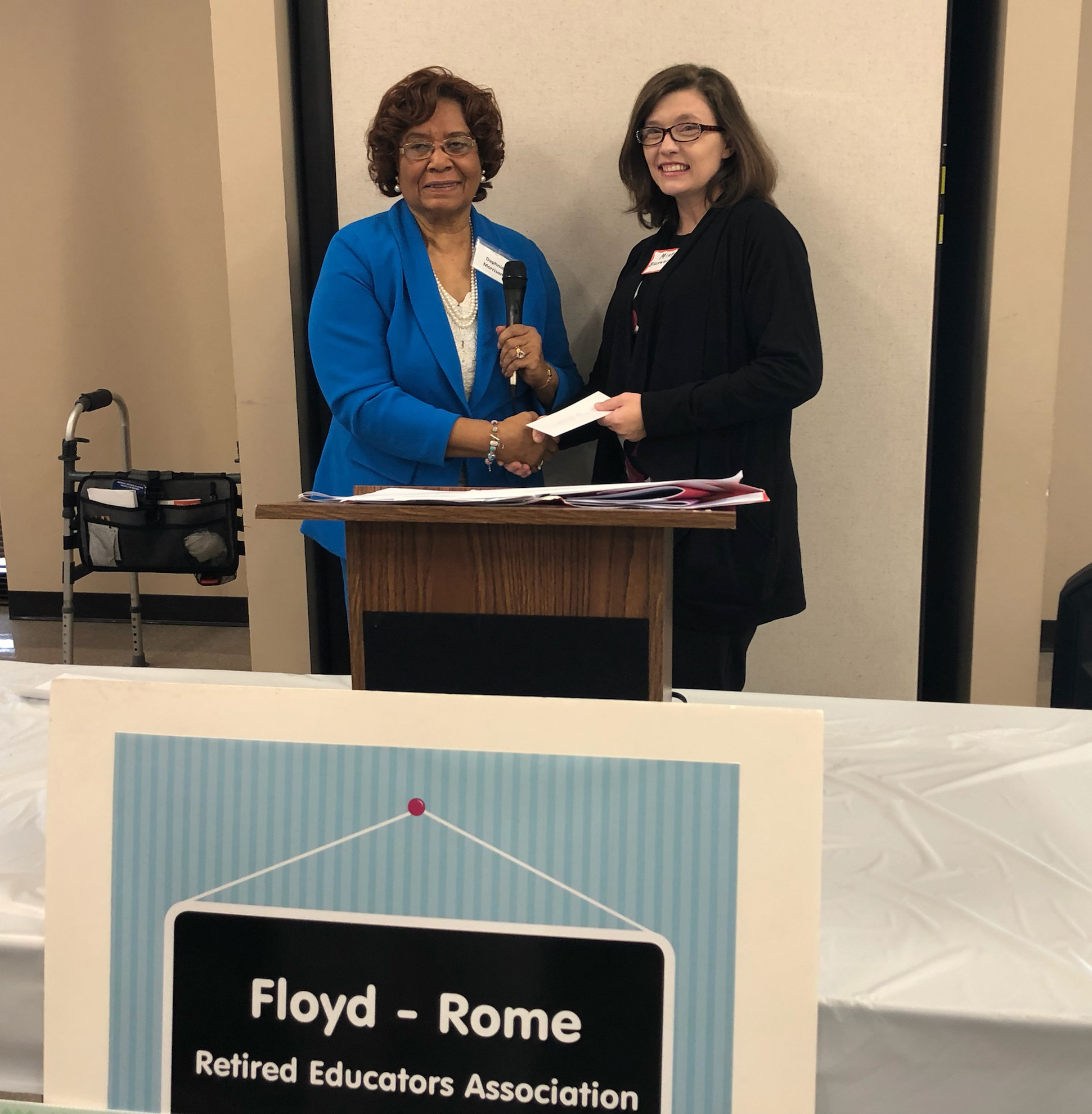 GNTC Early Childhood Care and Education student Misty Blasengame (right) receives a $1,000 scholarship from Daphnie Morrison (left) during a luncheon for the Floyd-Rome Retired Educators Association.