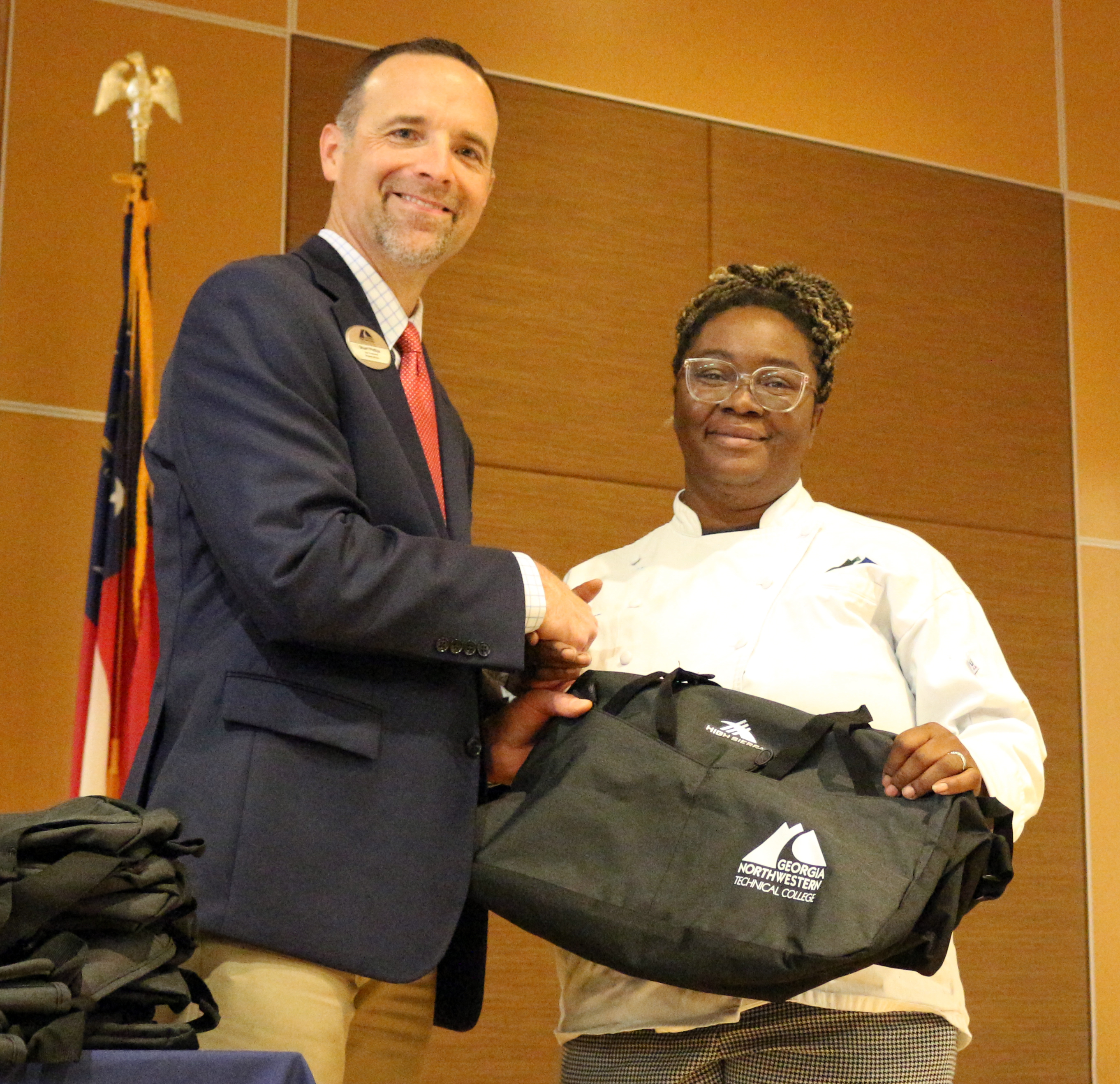 Stuart Phillips (left), vice president of Student Affairs at GNTC, recognizes Stephanie Follins for representing GNTC in Baking and Pastry Arts competition at the 2024 SkillsUSA Georgia State Leadership and Skills Conference.