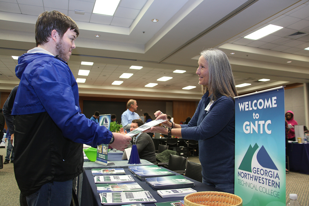 Cody Hughes (left), a student at Armuchee High School, talks with Donna Scott, GNTC director of  student success and campus manager, who gives him information on what the college does as well as how to apply. 