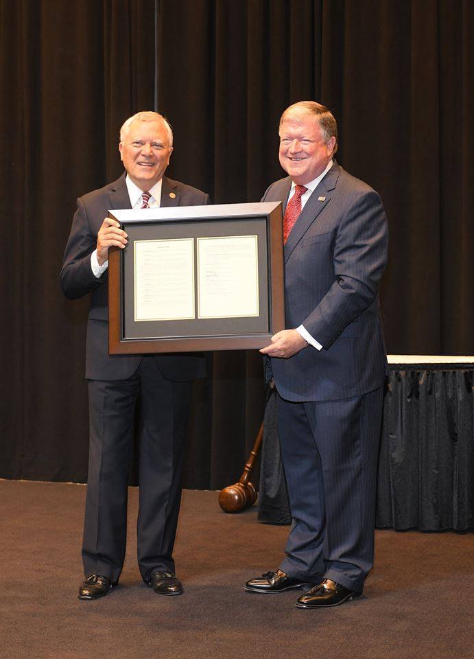 Georgia Governor Nathan Deal, left, holds a proclamation presented to him by Technical College System of Georgia Board Member Joe Yarbrough. The proclamation honoring Deal’s service to Georgia also highlights a new scholarship being created in his honor. The Nathan Deal Scholarship program will benefit students who attend Georgia Northwestern Technical College.