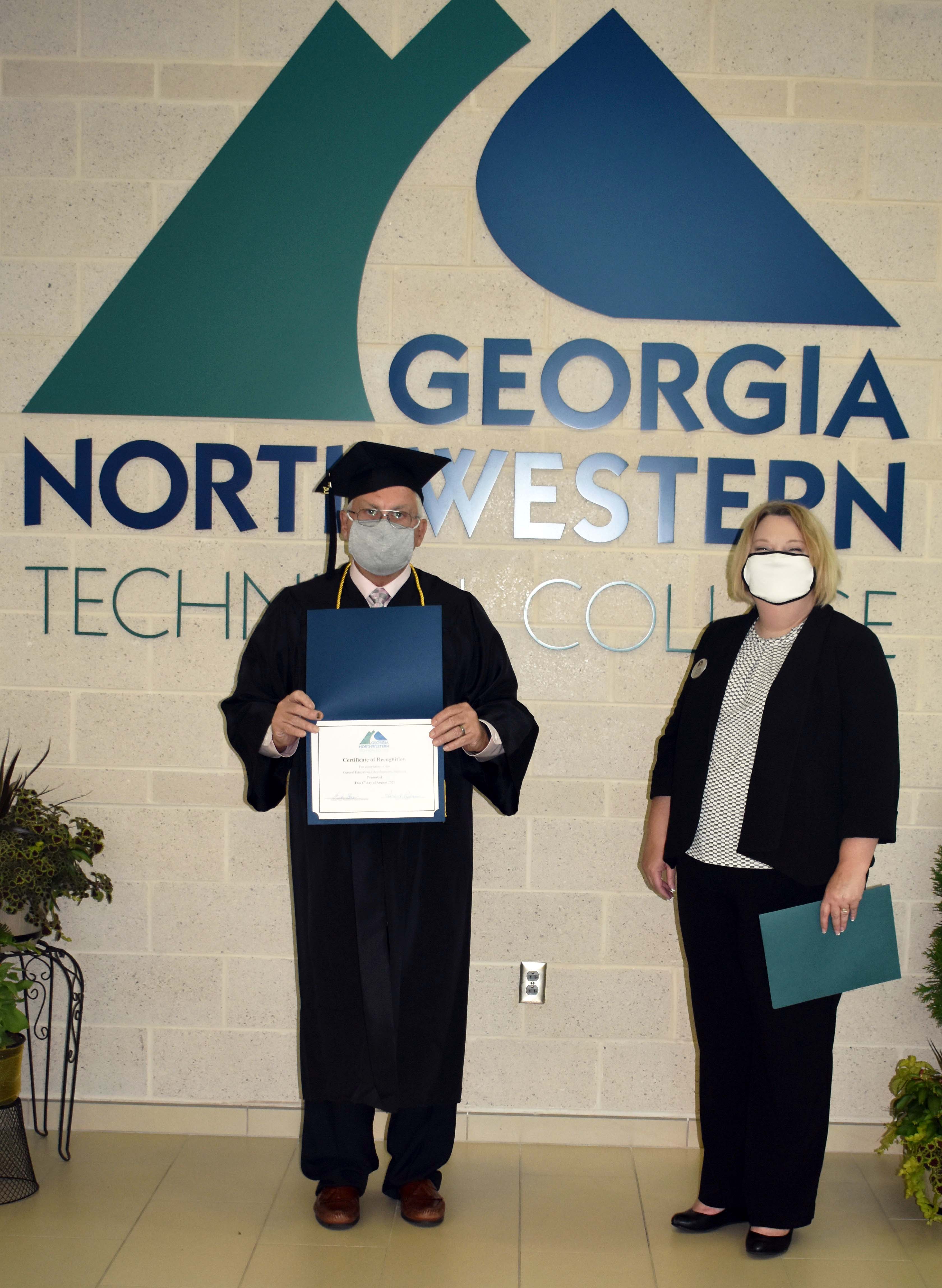 Jim Gunter of Rossville (left), stands with Lisa Shaw, GNTC vice president of Adult Education, during Georgia Northwestern Technical College’s Adult Education graduation celebration at the Catoosa County Campus.