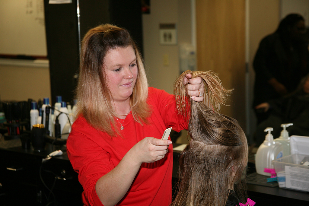 Alicia Flowers, a resident of Cave Springs, styles a client’s hair during GNTC’s Valentine’s Spa Day for women on Feb. 12.