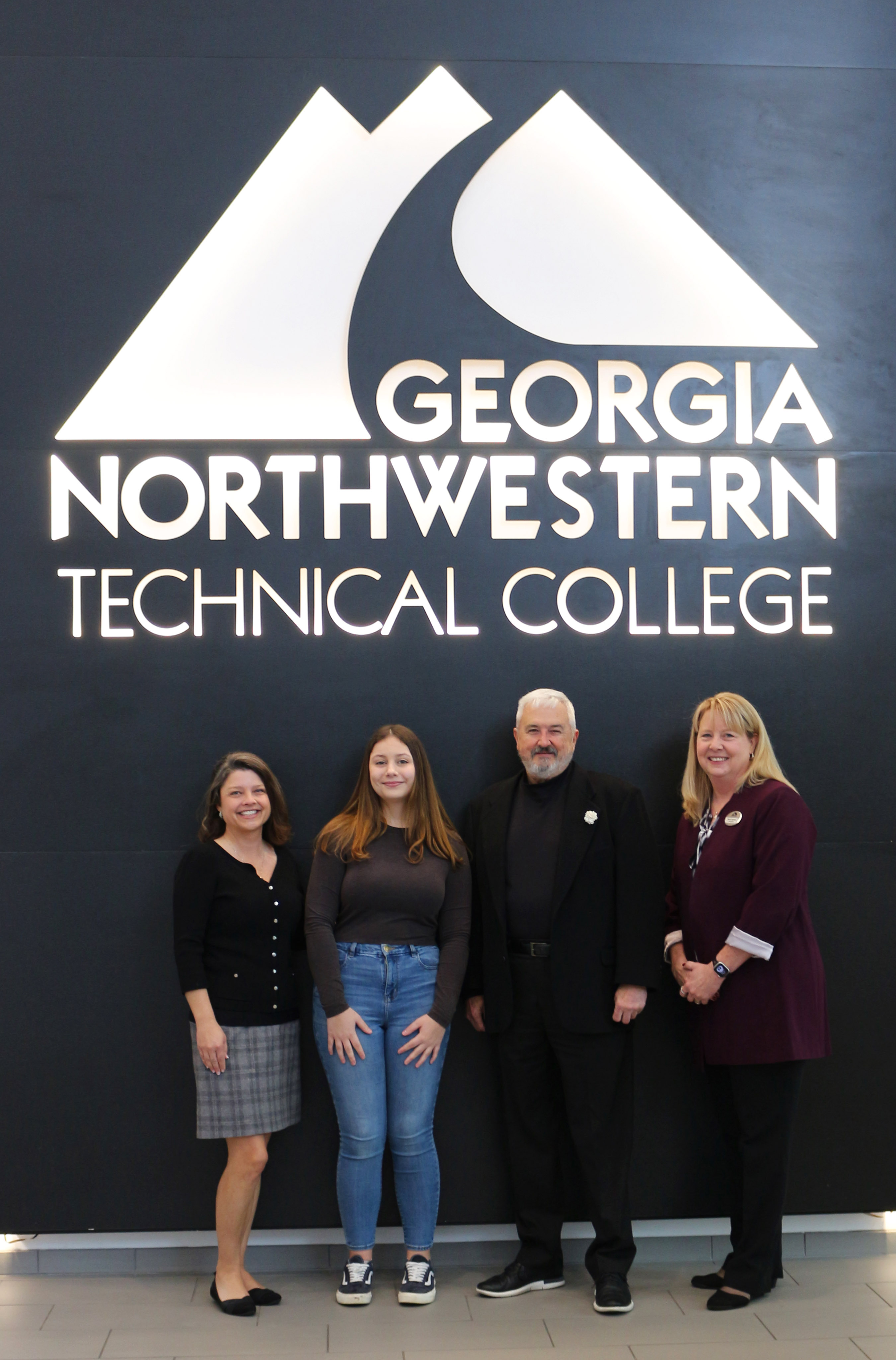 (From left) Amanda Reed, chief strategy officer of Alliant Health Plans and Health One Alliance; GNTC student Amber Brown; Mark Mixer, chief executive officer of Alliant Health Plans and Health One Alliance; and Dr. Heidi Popham, president of GNTC, celebrate Brown’s receipt of the Live4It Alliant Scholarship.