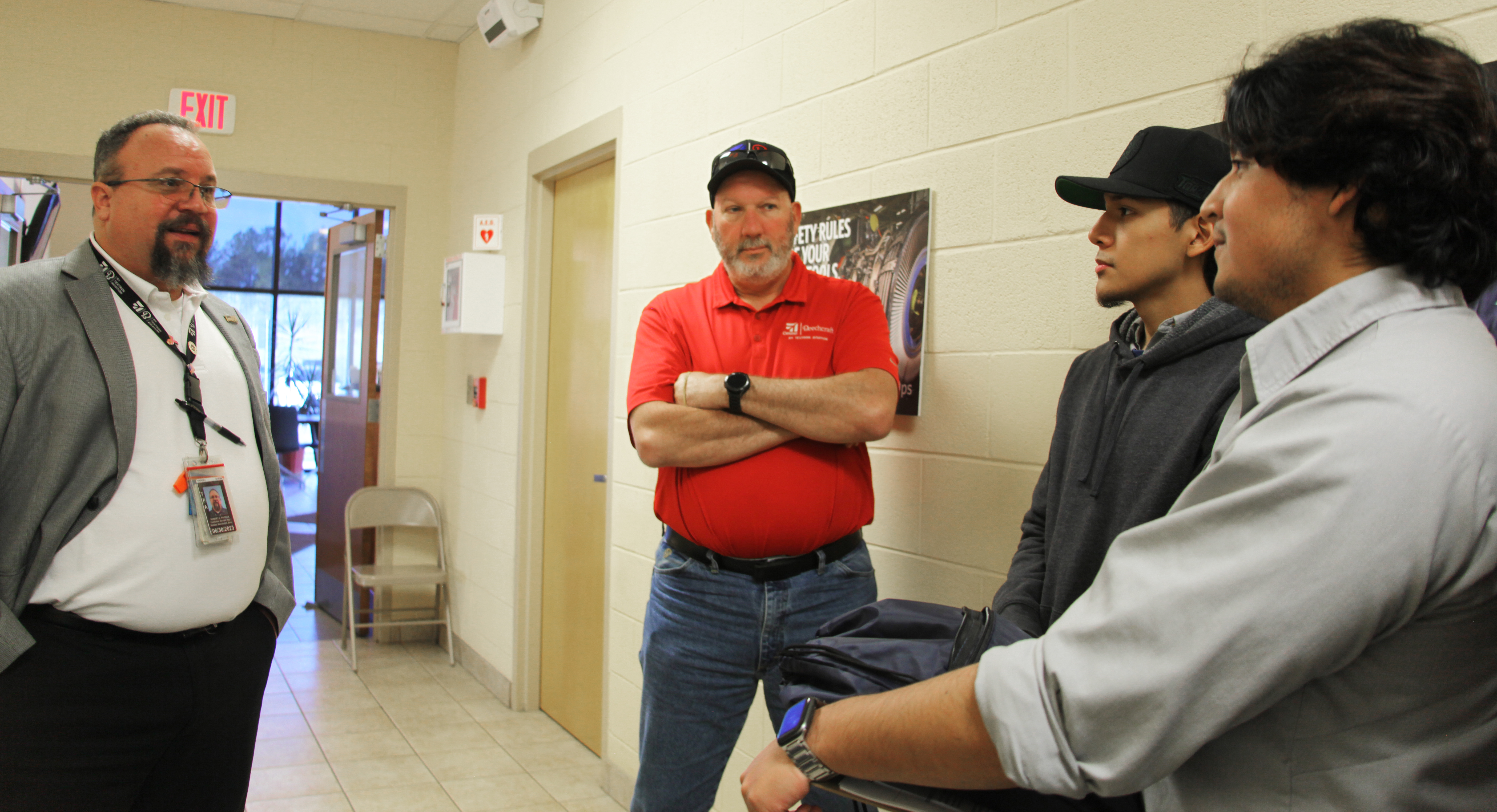 Textron Aviation service managers (from left) Robert Patrick and Phil Pezan discuss Textron job openings and requirements with GNTC students Cristian Gomez-Ramirez and Juan Lee.