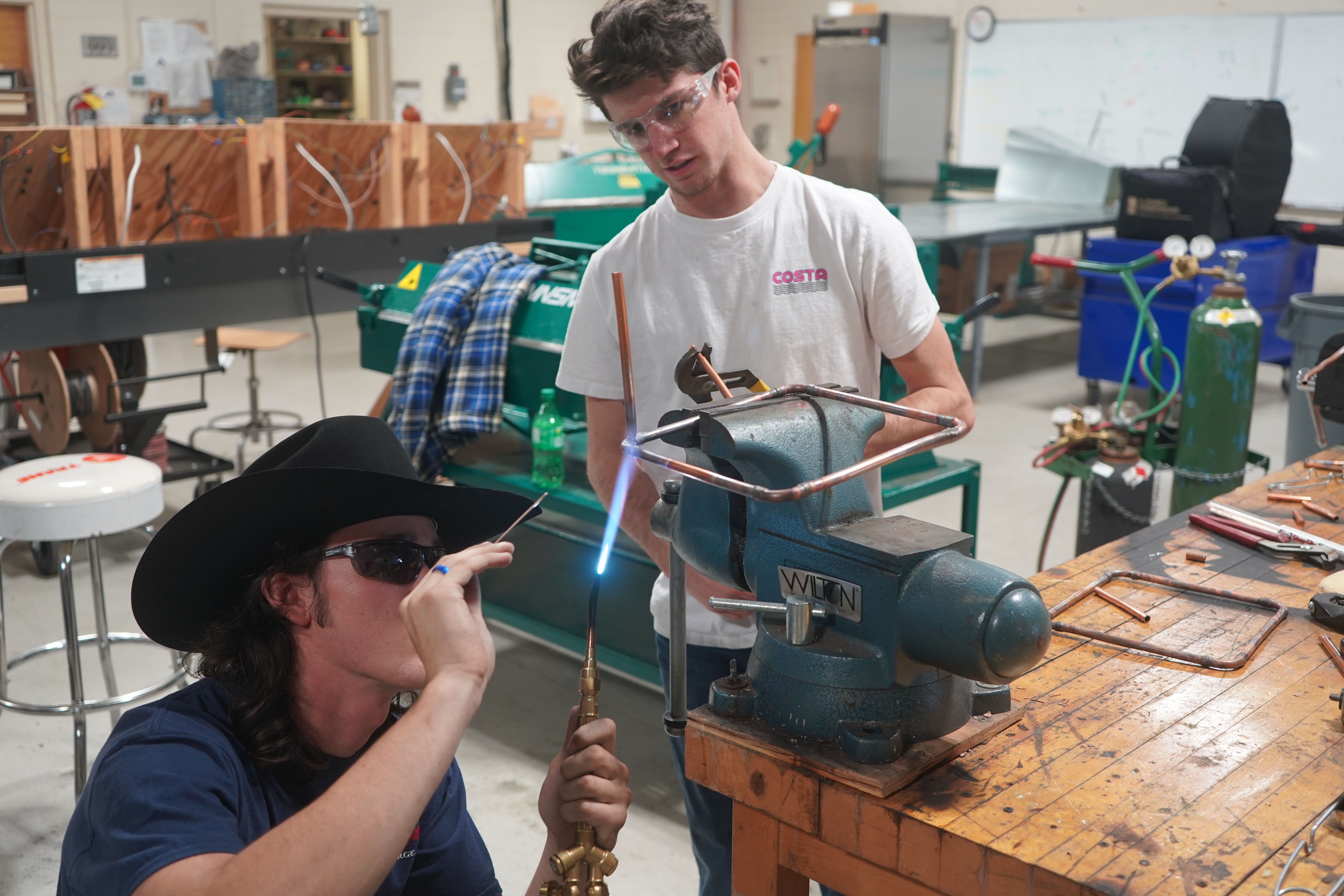 GNTC Air Conditioning Technology students Ben Stevenson (left) and Gabe Chapman (right) give a demonstration on brazing copper pipes during Industrial Career Day.