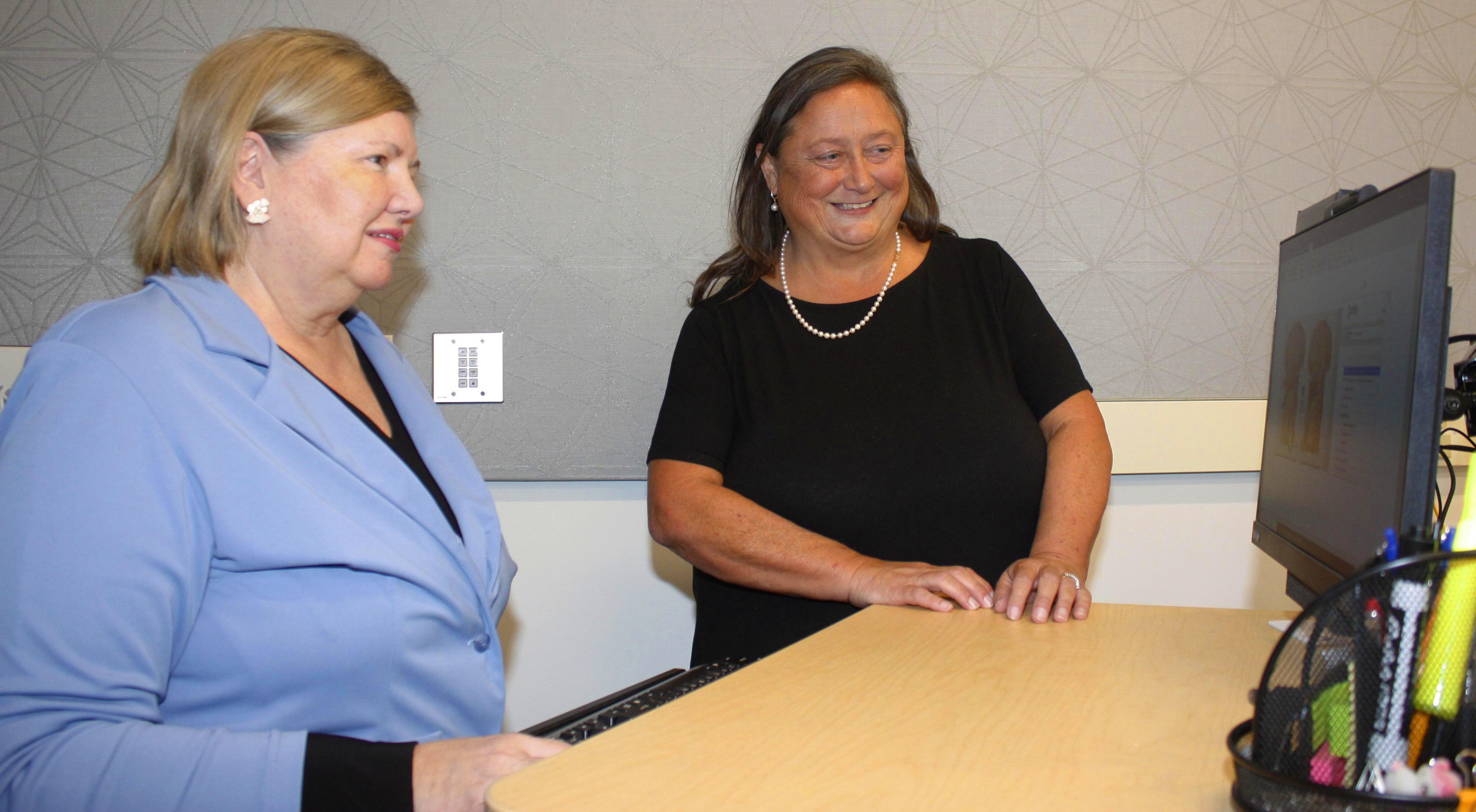 Lisa Hunt, GNTC’s program director of Business Healthcare Technology (left), and Gina Stephens, instructor of Business Administrative Technology, review the coding for a procedure.