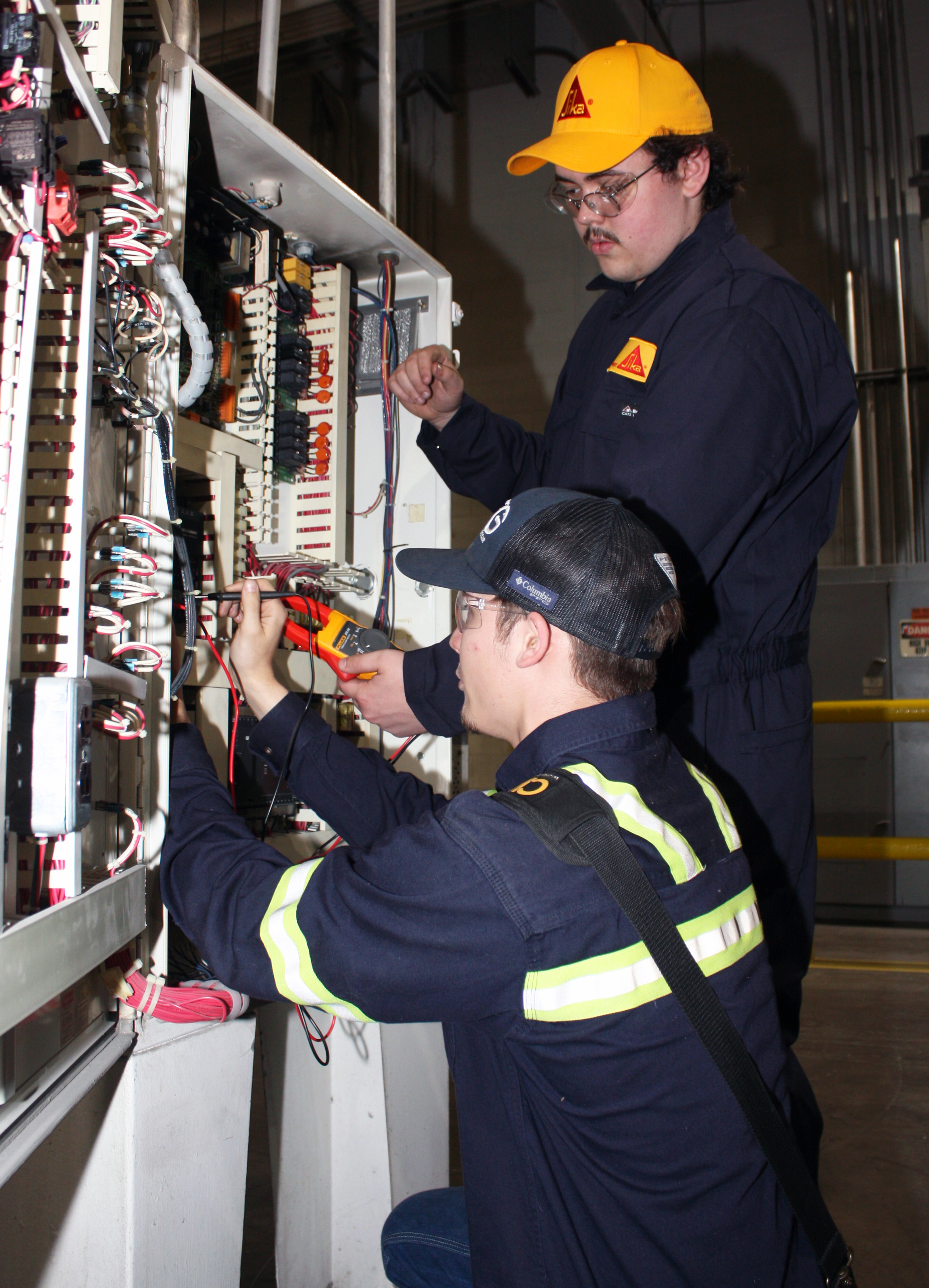 Zaniel Carroll (left) and Connor Hutchins at Sika trouble shoot the extrusion line controls cabinet at Sika Corp. in Chattanooga. Sika makes concrete reinforcement fibers and operates 24 hours a day, seven days a week.