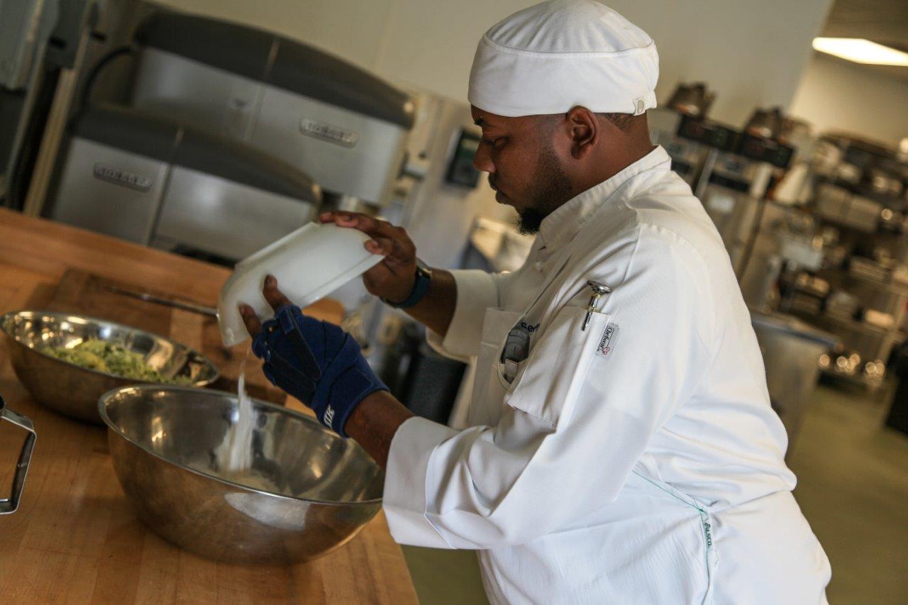 Georgia Northwestern Technical College Culinary Arts student Sedric Floyd of Rome, Georgia adds ingredients to a special muffin recipe he prepared during class at the Woodlee Building on the college’s Floyd County Campus.