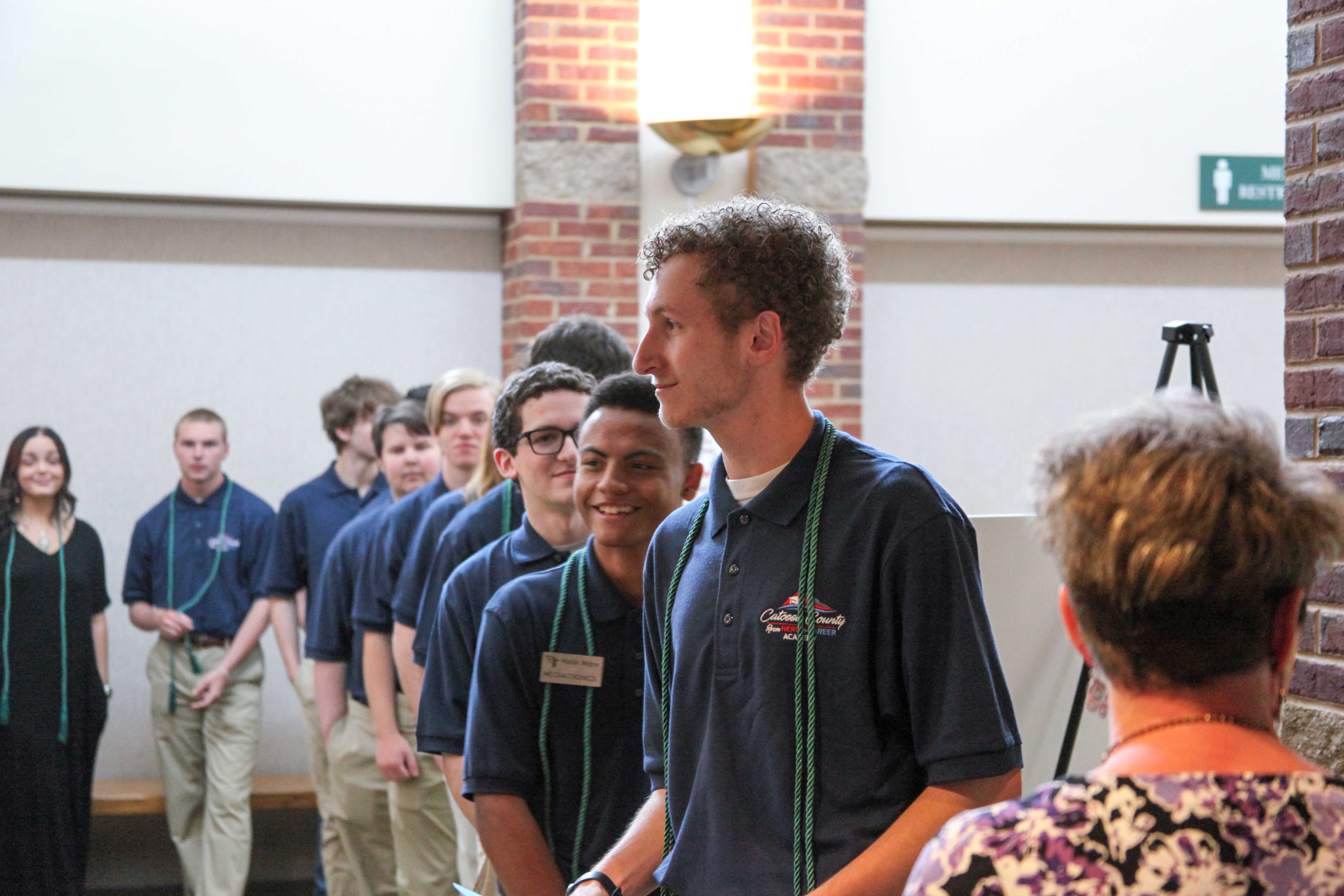Tyler Wolfe-Driver (center), a 2020 graduate of Ringgold High School and From HERE to CAREER! Academy, leads the procession of 13 CCPS students during the From HERE to CAREER! Academy Mechatronics Student Recognition and Cording Ceremony. Wolfe-Driver, a current student at the University of Tennessee at Chattanooga, spoke during the event about his time at CCPS. 