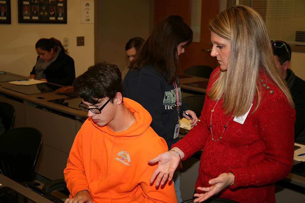 Crista Resch (right), instructor of Vascular Technology and clinical coordinator at GNTC, helps Chase Helton (left) of Rome get registered for classes during orientation.