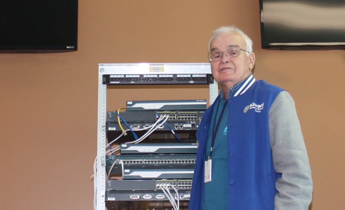 Dwight Watt poses with technology GNTC uses in its Cybersecurity program.