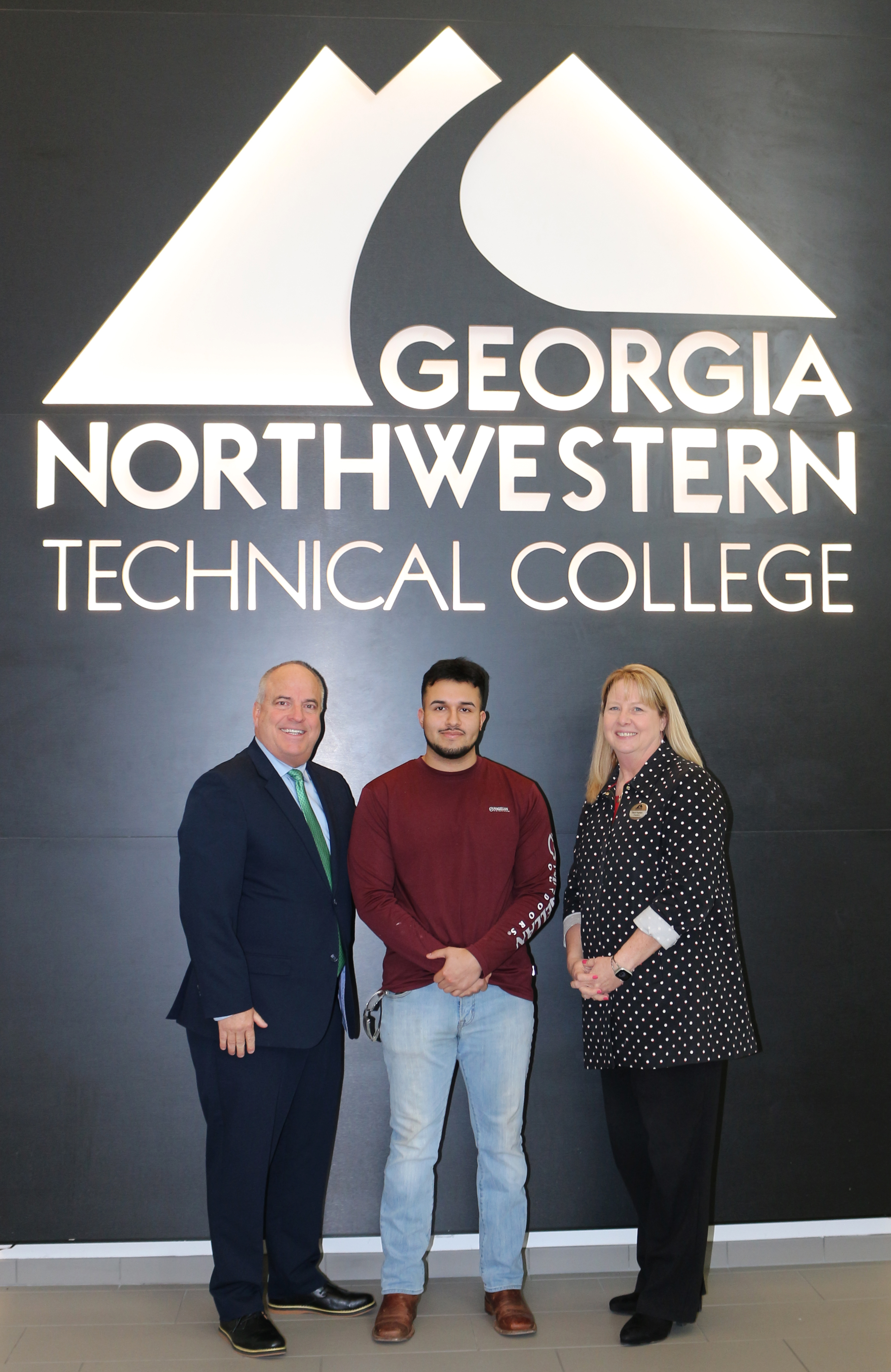(From left) Russ DeLozier, The Carpet and Rug Institute president; GNTC student Angel Cruz, recipient of The Governor Nathan Deal Technical Education Scholarship; and Dr. Heidi Popham, GNTC president.