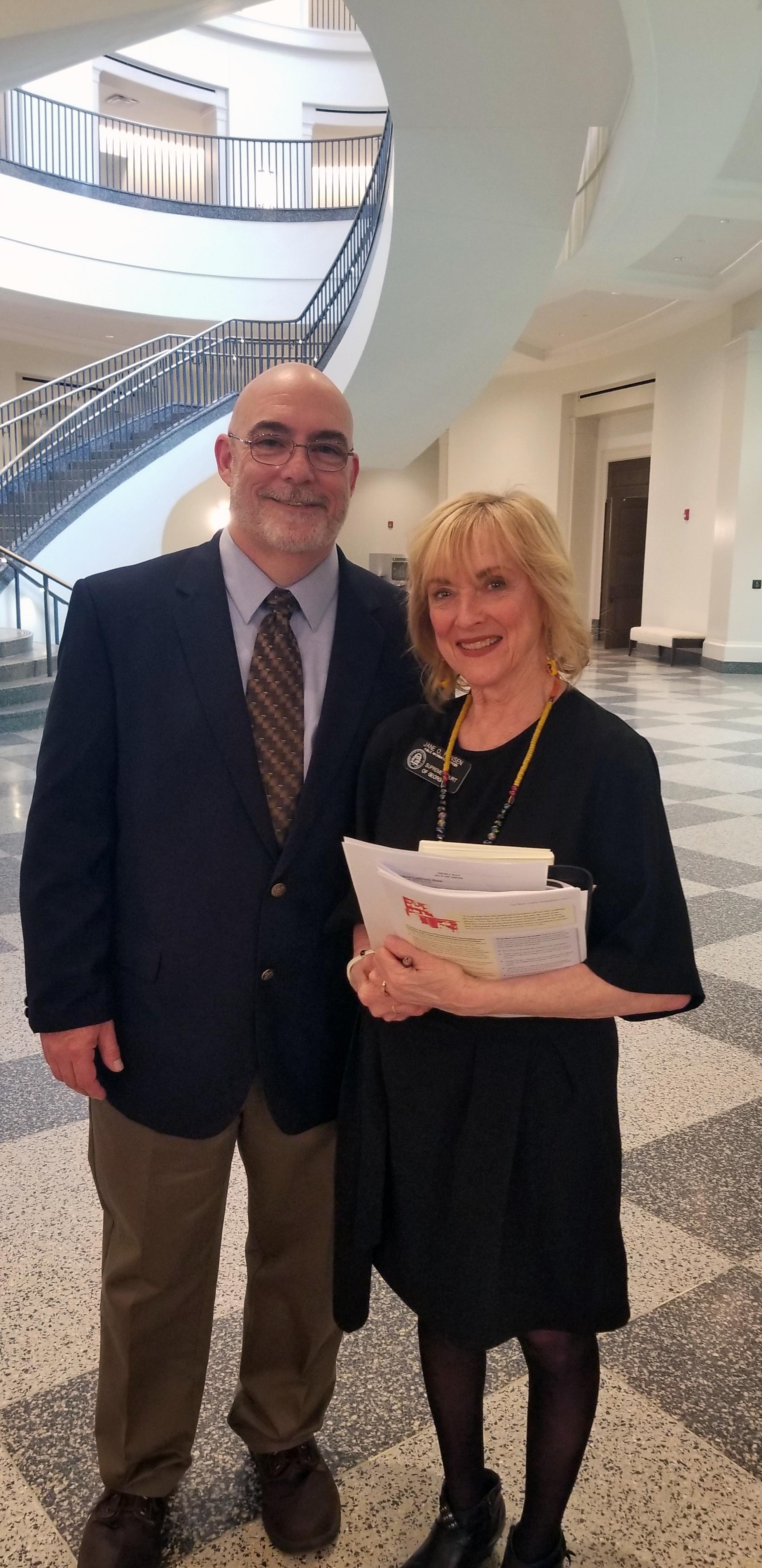 GNTC student William Rutledge (left), stands with Jane Hansen, conference of court public information officer for the Supreme Court of Georgia, during the installation of a conference table designed by Rutledge while he was in prison.