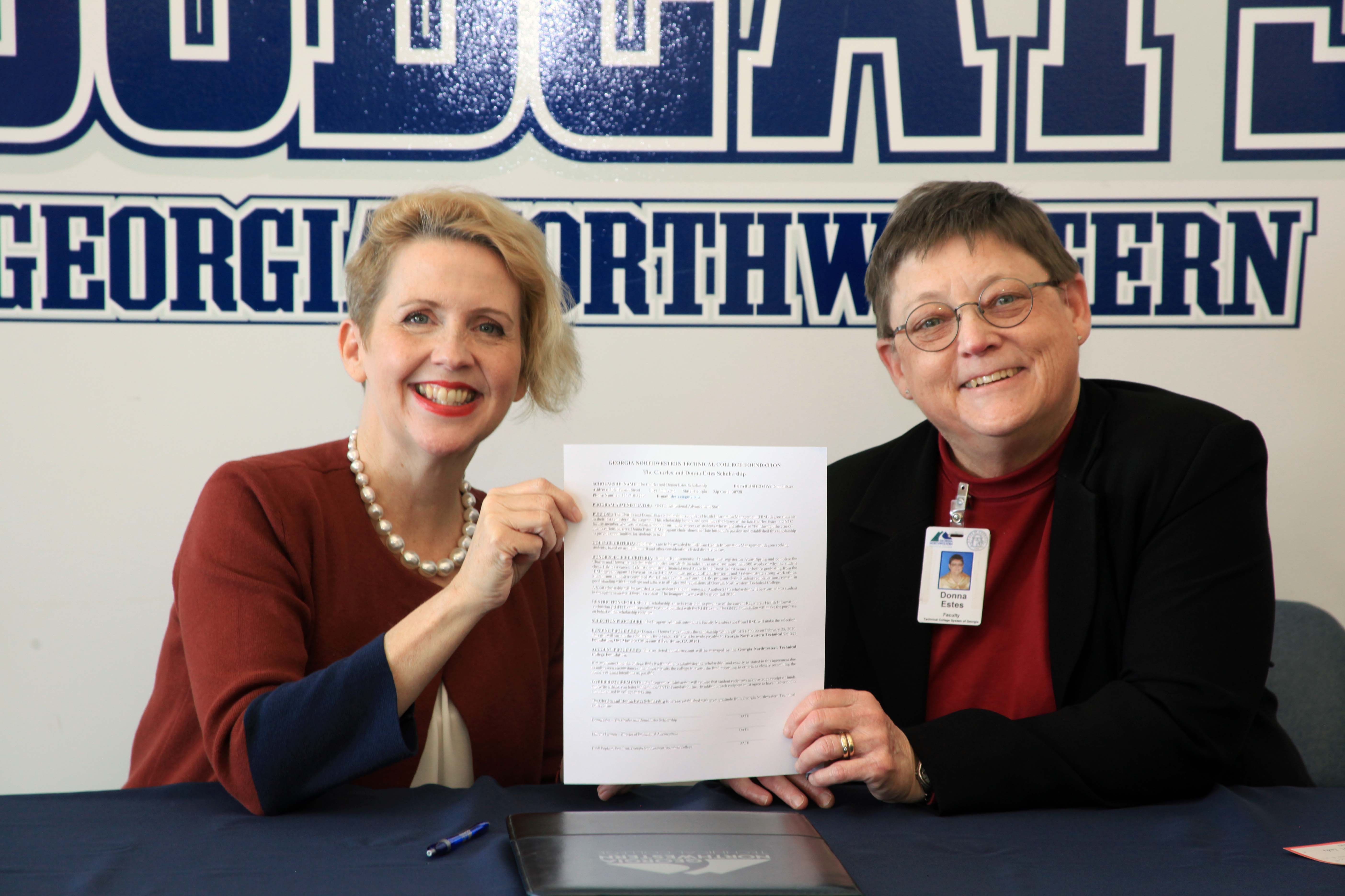 Lauretta Hannon (left), director of Institutional Advancement for GNTC, and Donna Estes, program director and instructor of Health Information Management Technology, sign the paperwork to establish the Charles and Donna Estes Scholarship.