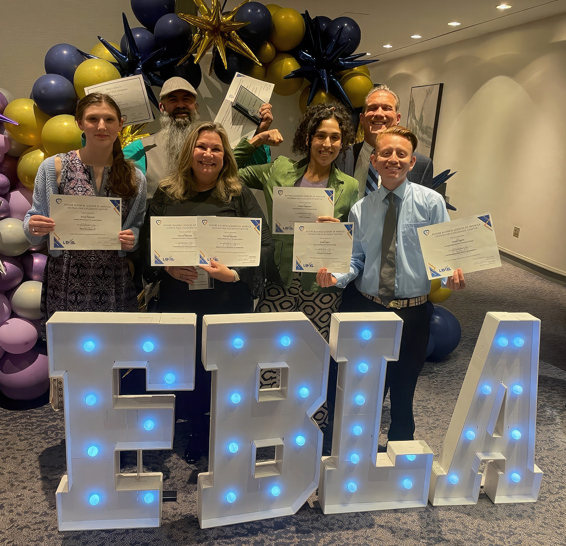 (Clockwise from top right) Mark Upton, Marketing Management program director and FBLA coordinator at GNTC, congratulates GNTC students Josue Lopez, Esther Johnson, Nancy Johnson, Anna Cantrell and Brandon Wishon. The five students have qualified to compete in June in the Future Business Leaders of America Collegiate National Leadership Conference in Orlando. 