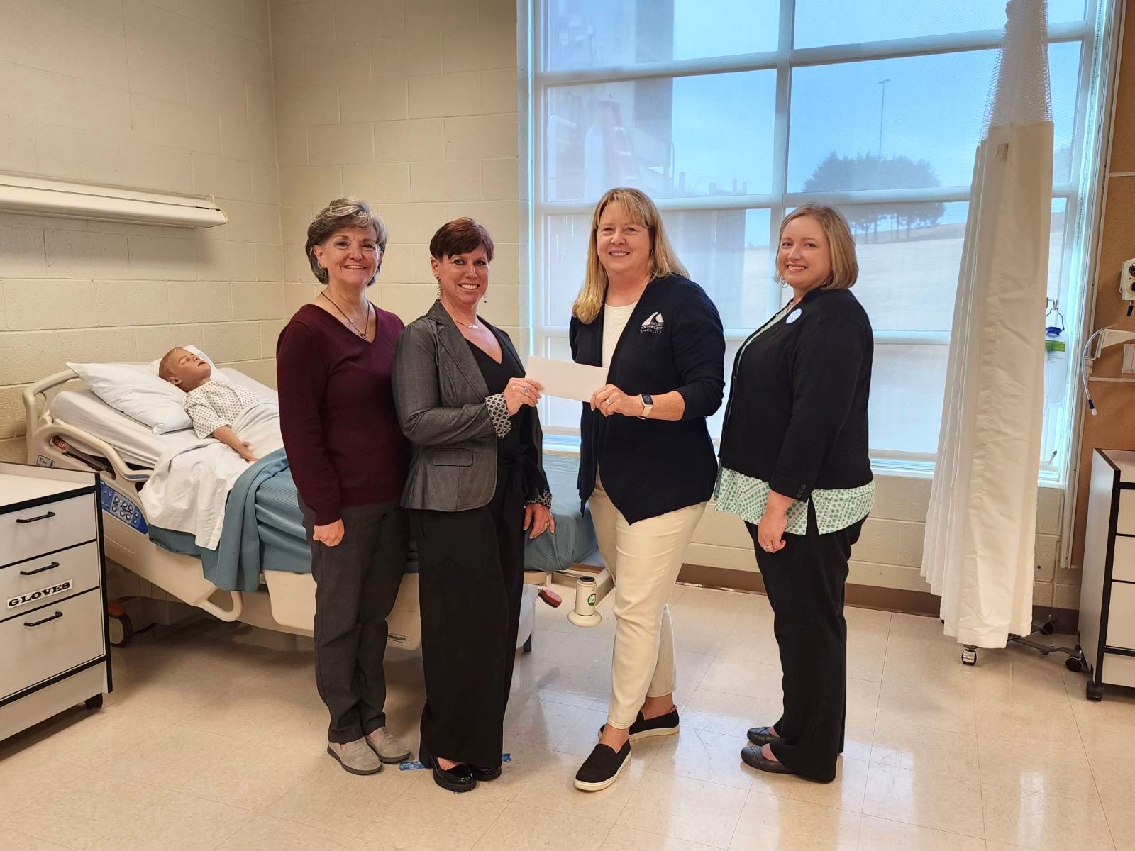 (From left) Michelle Spears-Sevy, Registered Nursing program administrator and instructor at GNTC; Kymberly Davis-Grahn, a student in the Associate of Science in Nursing program at GNTC; Dr. Heidi Popham, GNTC president; and Jennifer Loudermilk, associate vice president of Academic Affairs at GNTC, celebrate Davis-Grahn receiving the Amerigroup Rural Georgia Nursing Scholarship. 