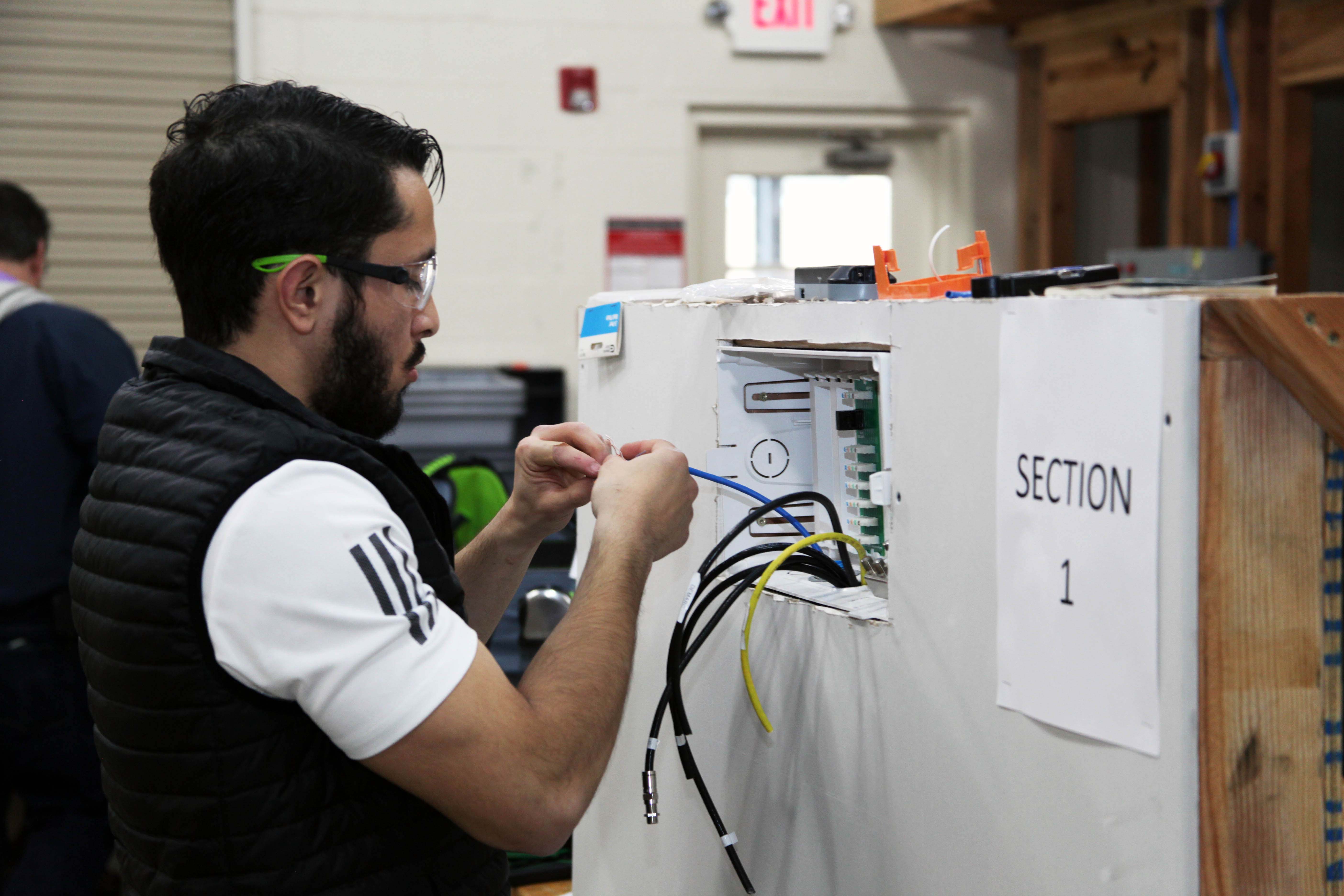 GNTC Electrical Systems Technology student Daniel Carrillo attaches a connector to a telecommunications cable during a SkillsUSA Georgia competition at the Floyd County Campus on Wednesday, March 11. 