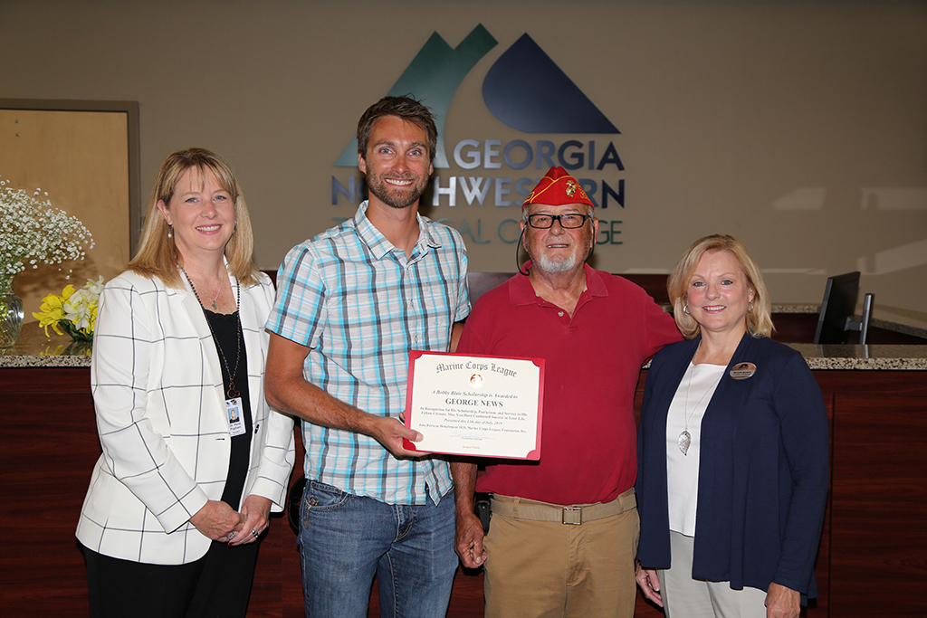 GNTC President Heidi Popham (from left) stands with recipient of the Bobby Blair grant George News, Troy Bolt of the Rome Marine Corps League, and Michelle Beatson, Foundation Administrator at GNTC. 