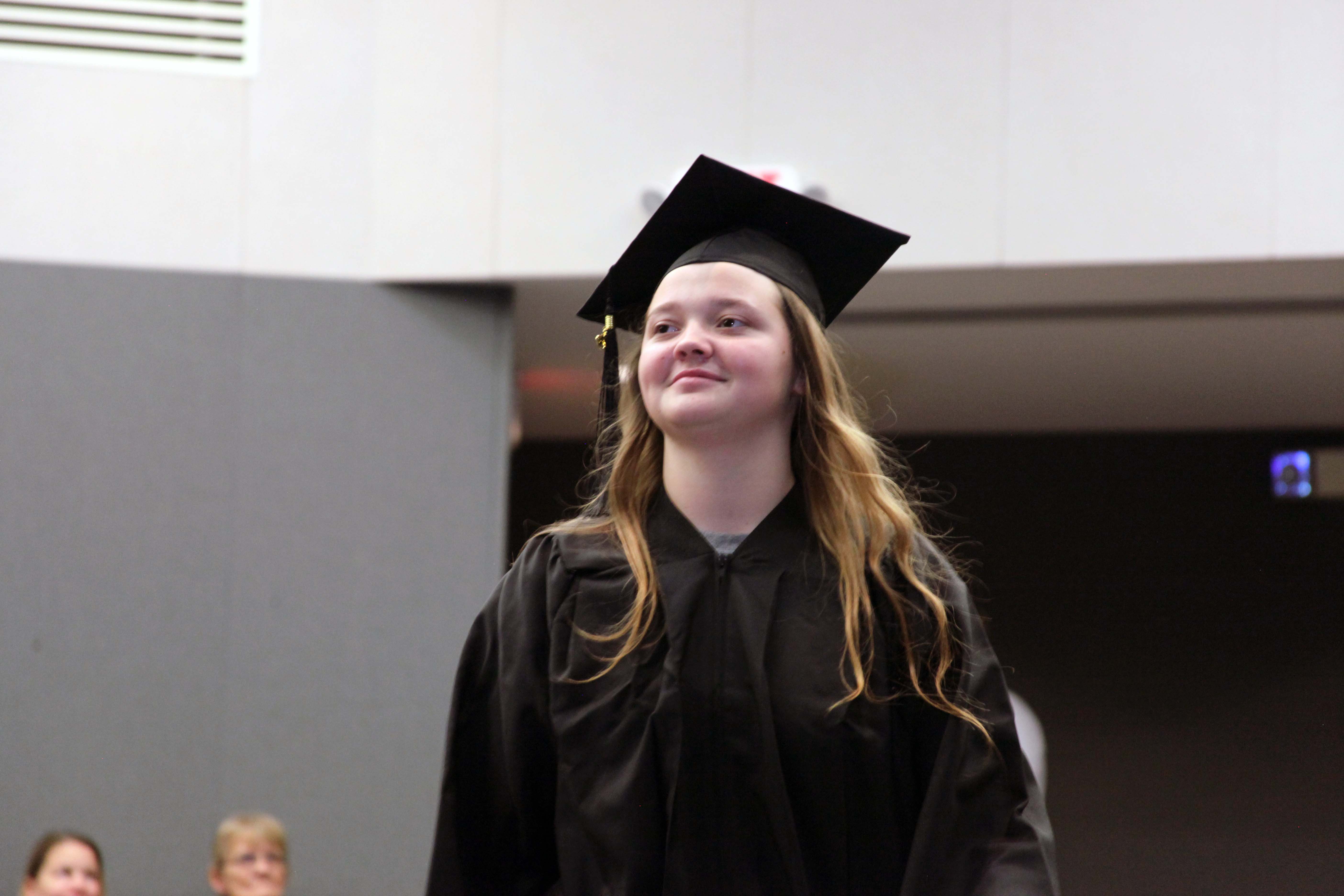 Lexington Fisher walks into the auditorium on the GNTC Floyd County Campus just before receiving her GED® diploma from the Youth Success Academy.