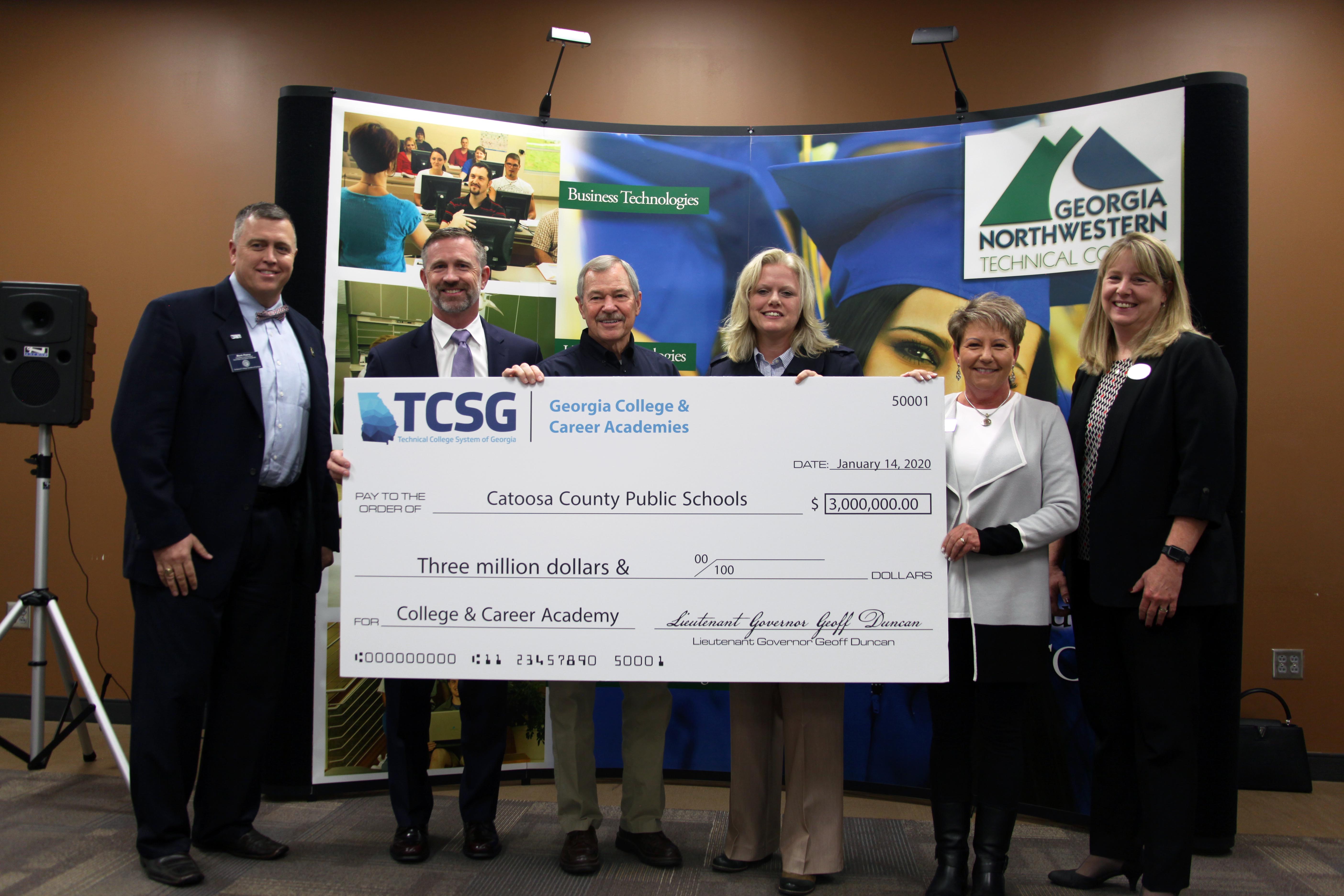 Mark Peevy (from left), assistant commissioner of Secondary Education Initiatives for TCSG, stands with Jonathan Connell, Board of Directors chair for the From HERE to CAREER! Academy and owner of MedSTAT; Don Dycus, chairman of the Catoosa County Public Schools Board of Education; Jenny Williams, director of the Office of College and Career Transitions at TCSG; Denia Reese, superintendent of Catoosa County Public Schools; and Dr. Heidi Popham, president of GNTC. The $3 million grant check presented to the school system will pay for 20% of its college and career academy. 