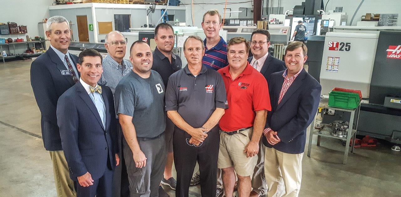 Visiting Densmore Machine in Whitfield County, Georgia to recognize the gift to Georgia Northwestern Technical College were industry and local leaders from across Northwest Georgia. Shown in the front row, from left, are Rob Bradham, President and Chief Executive Officer of the Greater Dalton Chamber of Commerce; Johnathon Densmore, Chief Operating Officer of Densmore Machine; David Aycock, Jeffreys Manufacturing Solutions; John Densmore, Jr., Chief Executive Officer of Densmore Machine, and Carl Campbell, Vice President of Economic Development of the Greater Dalton Chamber of Commerce. In the back row, from left, are Chuck Payne, Georgia State Senator District 54; Carl Roberts, Tooling Supplier and Engineer for Alternatives for Industry; Jimmy Densmore, Chief Financial Officer and Operations Manager of Densmore Machine; Phil Shirley, Machine Tool Technology Director at Georgia Northwestern Technical College, and Jason Gamel, Director of Institutional Advancement at Georgia Northwestern Technical College.