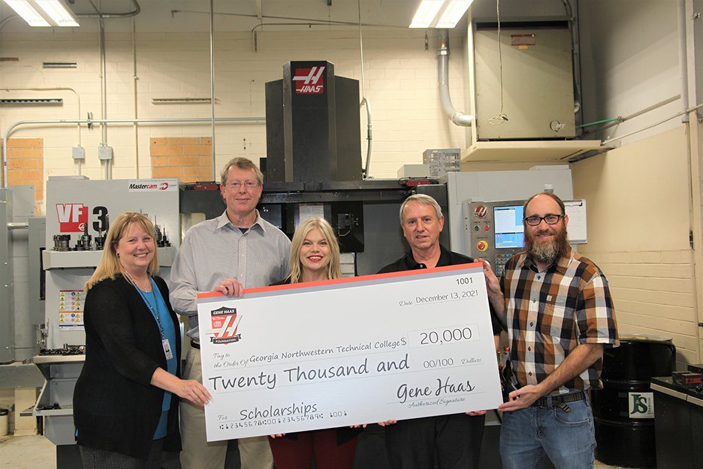 (From left to right) Dr. Heidi Popham, president of GNTC; Philip Shirley, Precision Machining and Manufacturing instructor; Lindsay Cline, director of Education and Events of Phillips Corporation; David Aycock, Haas specialist; Bart Jenkins, director of the Precision Machining and Manufacturing program at GNTC stand in front of a Haas Computer Numerical Control (CNC) machine at the Floyd County Campus. Cline and Aycock presented a grant of $20,000 to GNTC’s Precision Machining and Manufacturing program. 