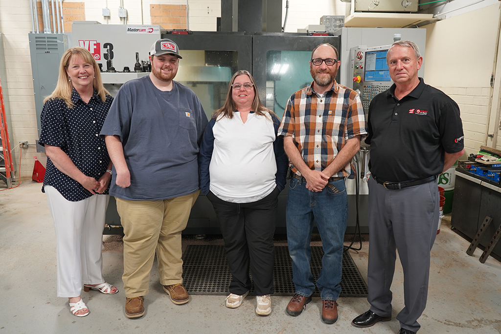 (From left) Dr. Heidi Popham, president of GNTC; Lane Mears, Gene Haas Scholarship recipient; Delores Turner, Gene Haas Scholarship recipient; Bart Jenkins, director and instructor of Precision Machining and Manufacturing at GNTC; and David Aycock, sales engineer for Phillips Corp./Haas Factory Outlet stand in front of a Haas CNC Milling Machine at GNTC’s Floyd County Campus in Rome.      