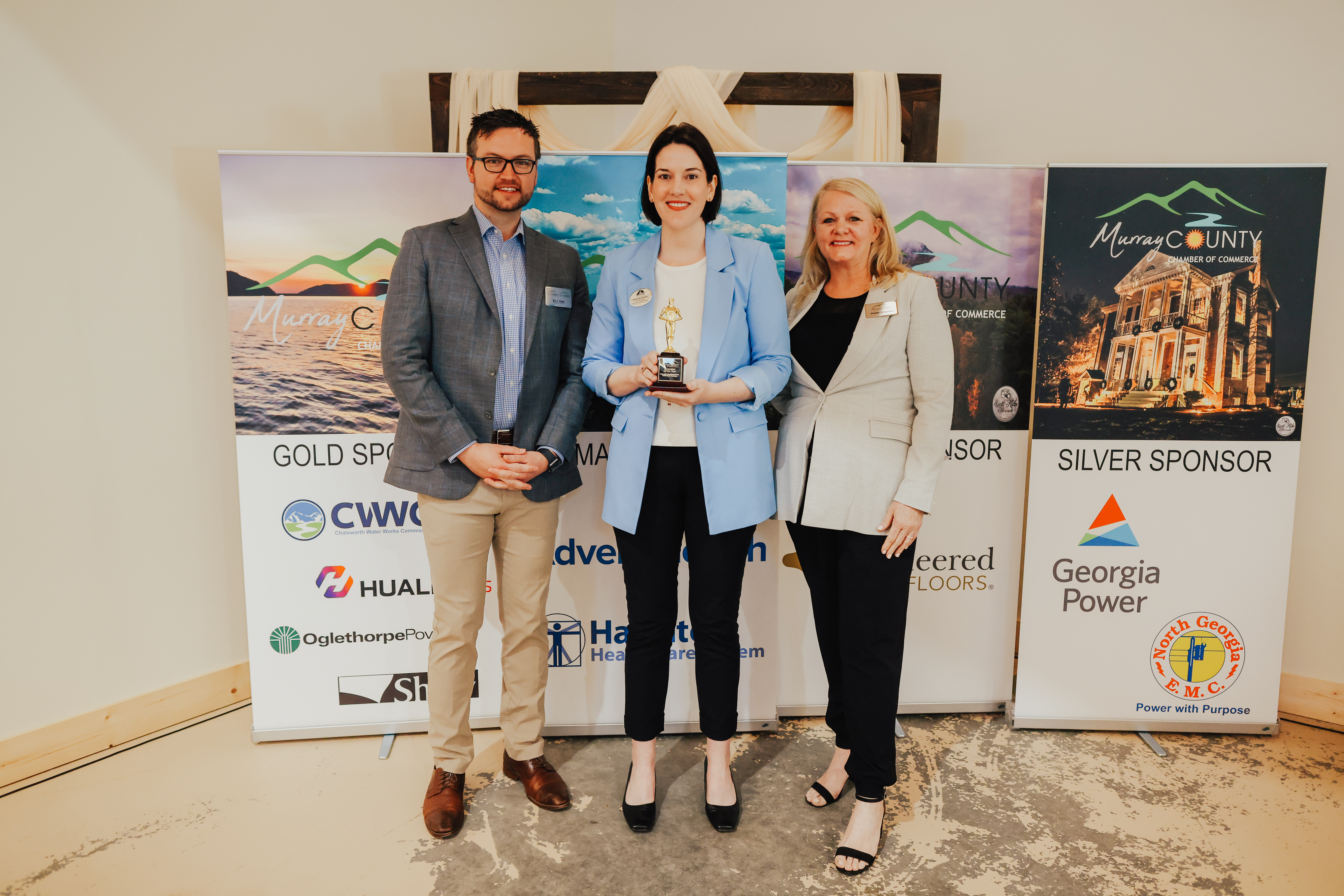 Stephanie Scearce, vice president of Economic Development at GNTC (center), accepts the Innovator of the Year Award from Eli Falls, president and CEO of the Murray County Chamber of Commerce and the Industrial Development Authority (left), and Sheila Simpson, chair of the Murray Chamber board. 