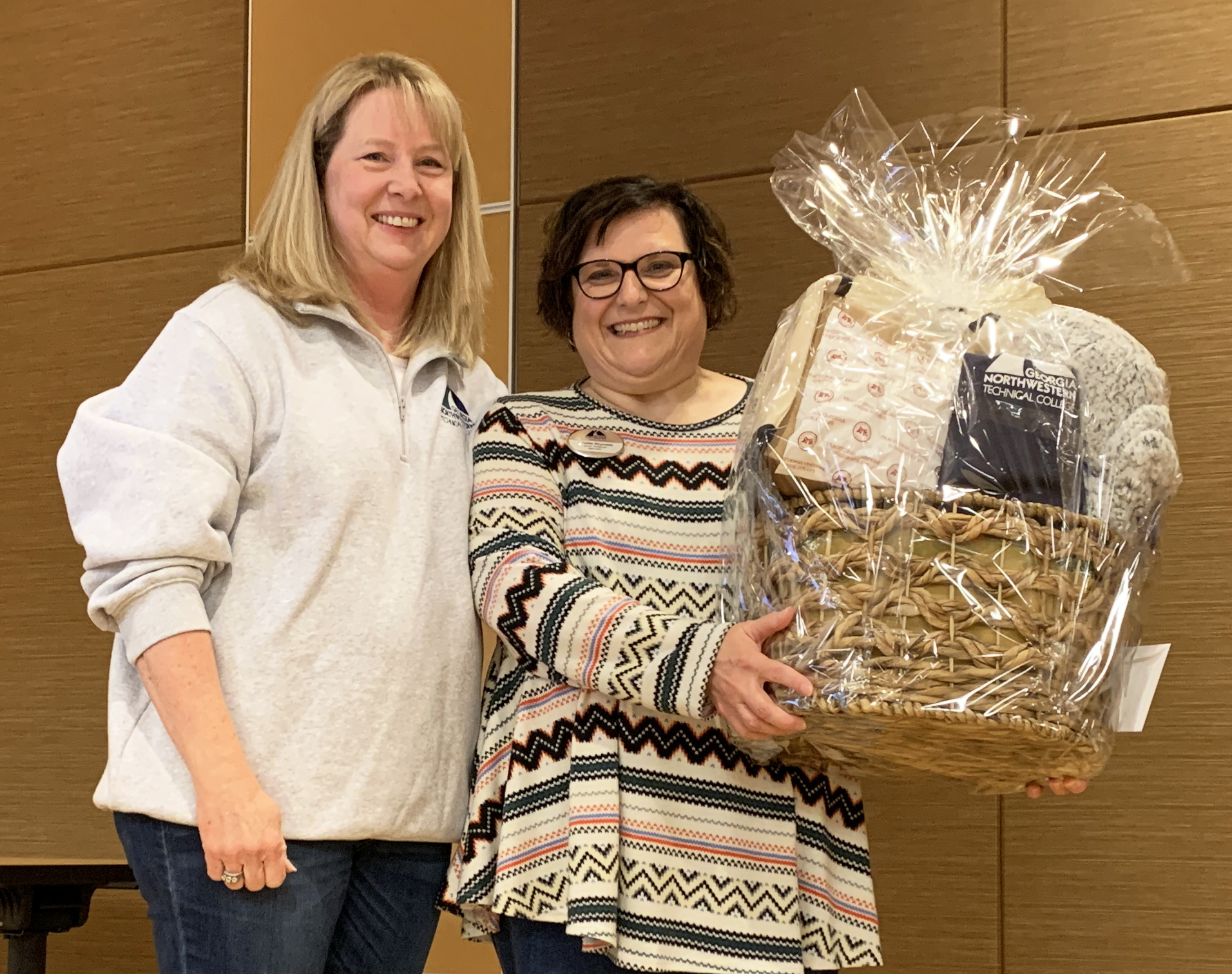 Dr. Heidi Popham, GNTC president (left), presents Jennifer Reynolds with a GNTC gift basket in recognition of her selection as GNTC’s 2024 Staff Member of the Year Award winner.
