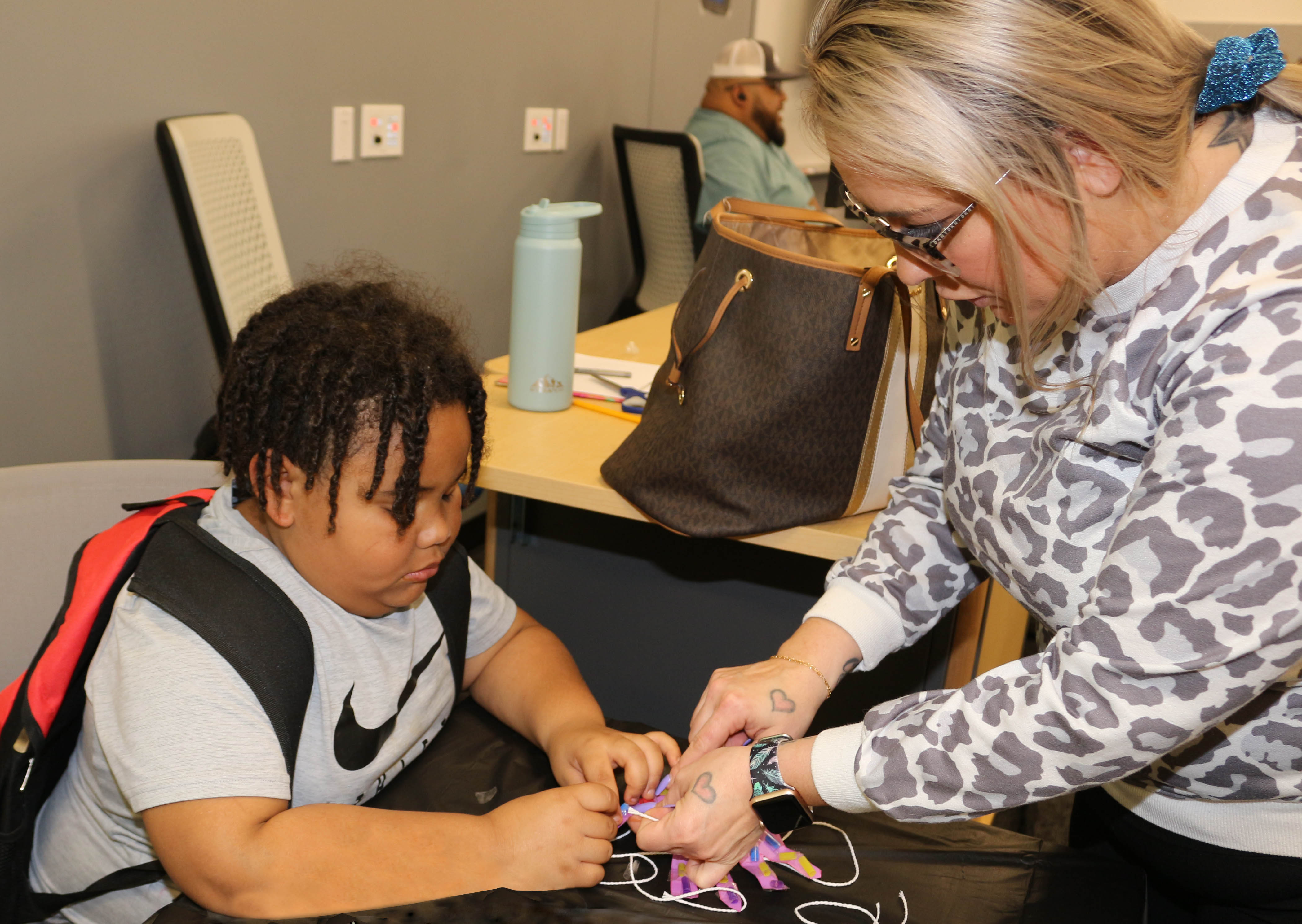 Tiffany Woodring (right) and her son, Trealyn Williams, create a hand that moves.