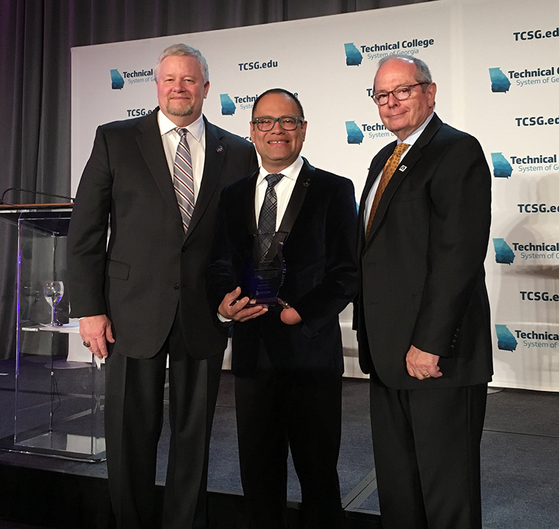 GNTC’s Leyner Argueta (center) was named the 2019 Instructor of the Year for the Technical College System of Georgia. Also pictured is TCSG Commissioner Matt Arthur (left) and Pete McDonald, president of GNTC.