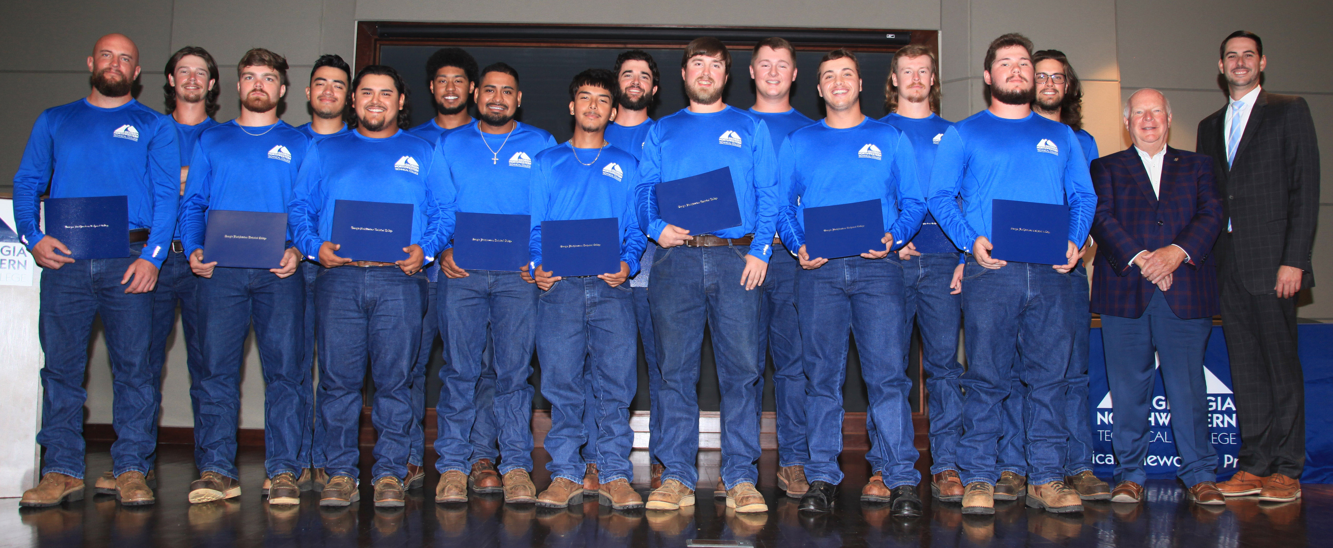 Rockmart Mayor Sherman Ross (second from right) and state Rep. Trey Kelley (right) congratulate the graduates of the third cohort of GNTC’s Electrical Lineworker program. The graduates are (from left, front) Dylan Blalock, Chandler Espy, Giovani Garcia, Luiz Alberto Rosas Valdez, Samuel Gomez Ramirez, Alec Ledbetter, Jeb Etheridge, Brenden Miller; (back) Nick Mullis, Humberto Cerda Jr., Xavier Clark, Neal Cochran, Peyton O’Neal, Austin Finch and Ridge Walker. 