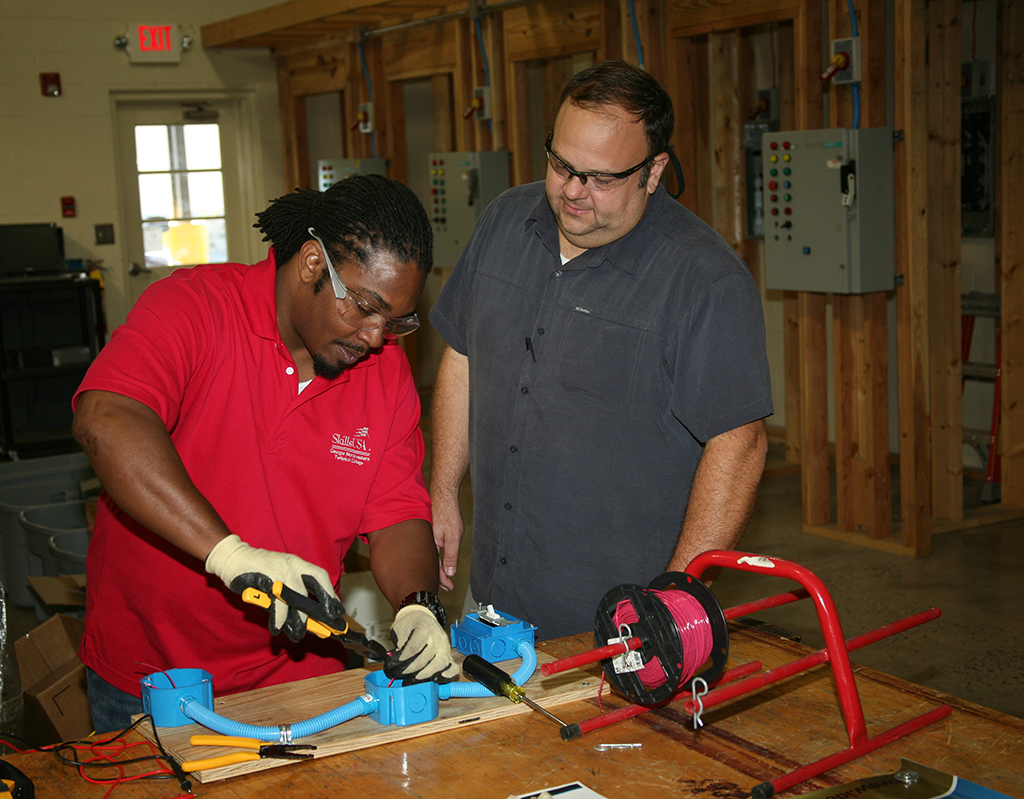 Melvin Mitchell (left), of Cartersville, works with IDEAL tools while Scott Carter (right), director of Electrical Systems Technology at GNTC, supervises in the electrical lab on the Floyd County Campus. Mitchell was part of the Career Pathways team that won the gold medal in the SkillsUSA Georgia competition and the bronze medal in the national SkillsUSA competition.  