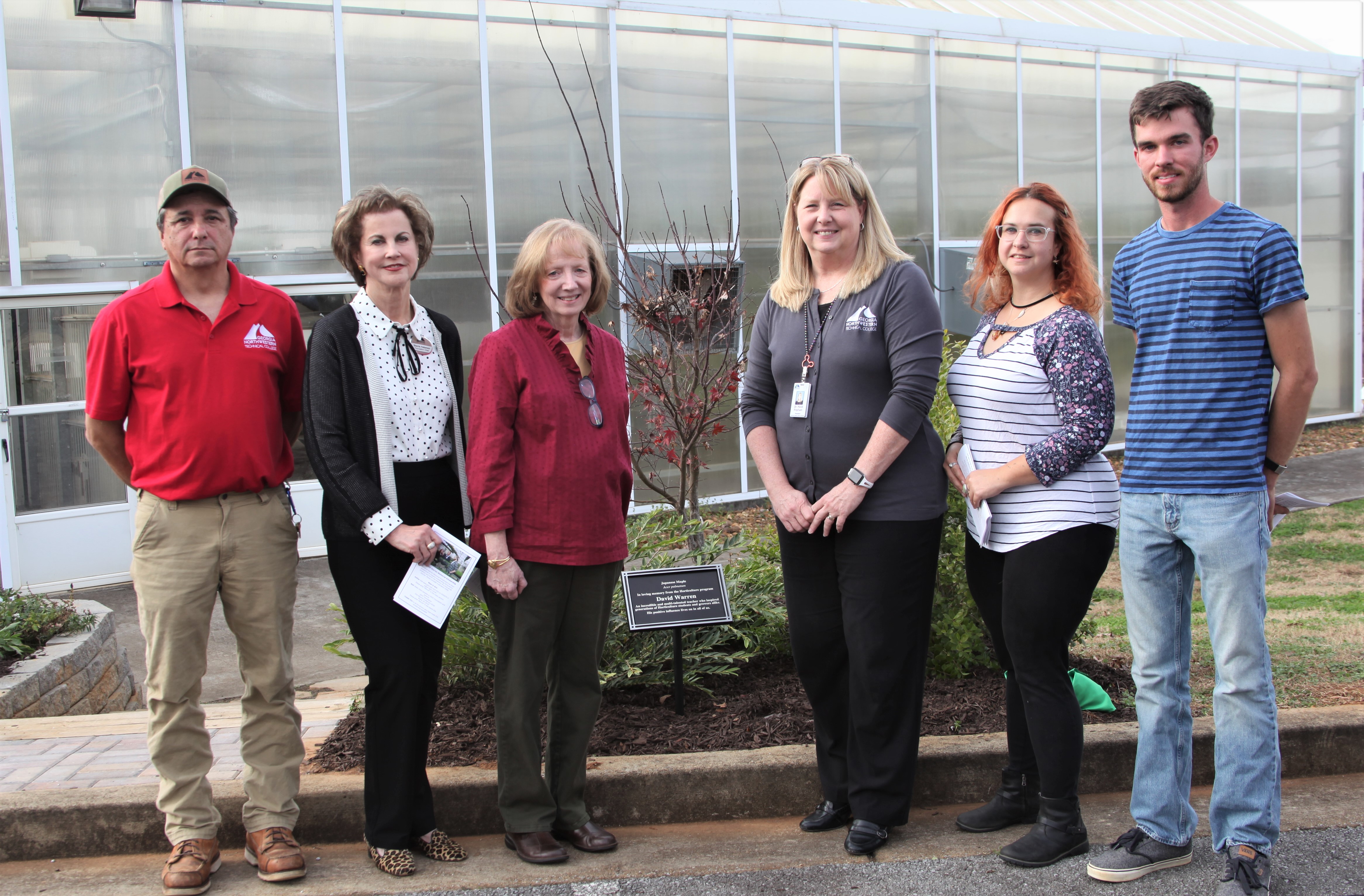 (From left to right) Nick Barton, director of GNTC’s Horticulture program; Sherrie Patterson, chair of the GNTC Foundation Board of Trustees; Dianne Warren; Dr. Heidi Popham, president of GNTC and GNTC Horticulture alumni, Alice Towe and Brandon Williams gather around the David Warren Memorial Tree located in front of the greenhouses of GNTC’s Floyd County Campus during the David Warren Tree Dedication and Scholarship Presentation held on Friday, Dec. 17.