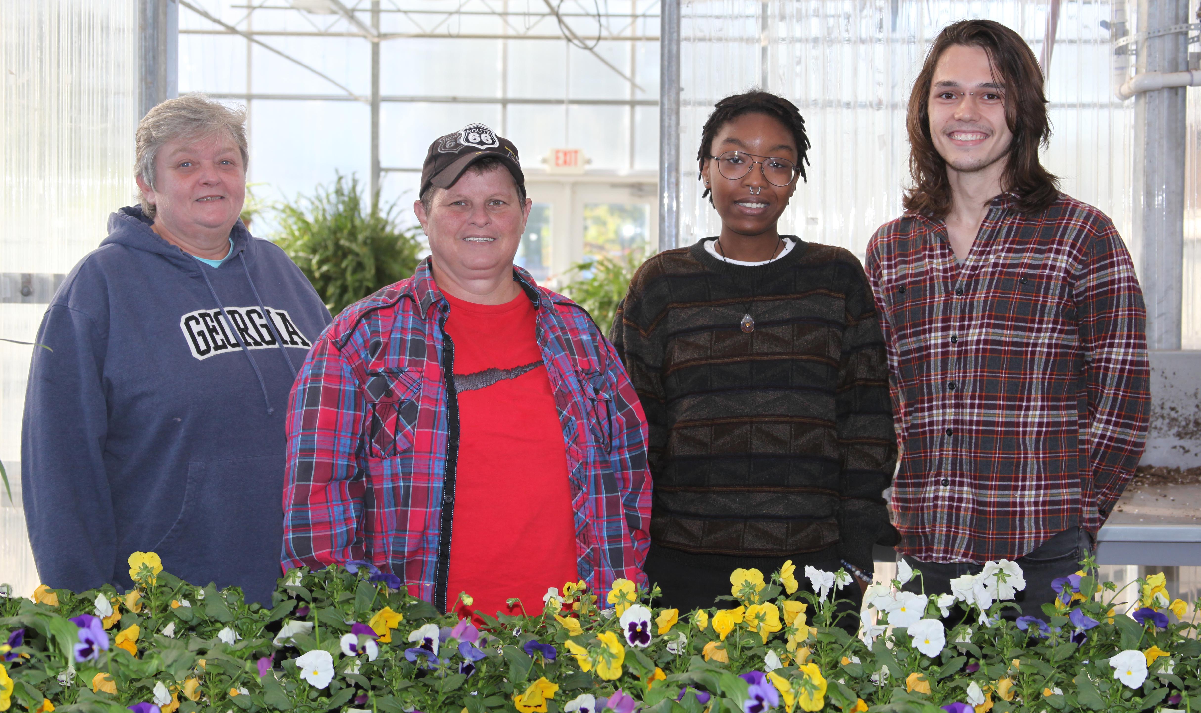 GNTC Horticulture students (from left) Cleta Farrow, Shanna Brown, Zee Hunnicutt and Logan Money prepare for the pansy sale.