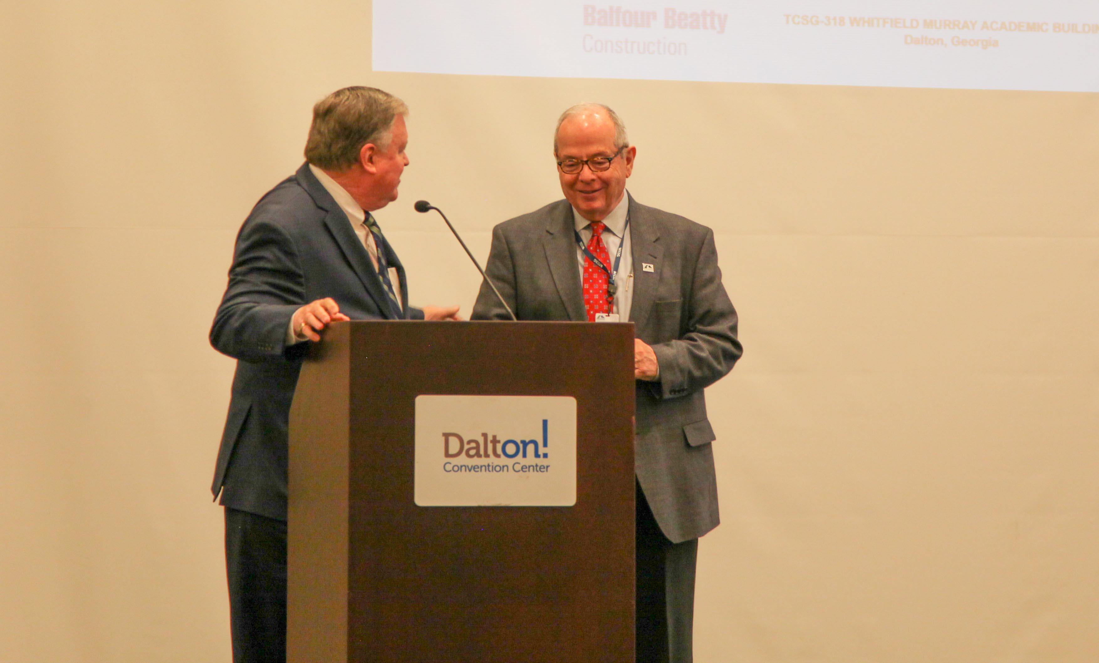 President and CEO of the Carpet and Rug Institute (CRI) and Technical College System of Georgia (TCSG) Board Member Joe Yarbrough, left, speaks on behalf of Georgia Northwestern Technical College President Pete McDonald. Yarbrough spoke in regards to McDonald’s pending retirement and his lifetime of dedication to higher education in Northwest Georgia.