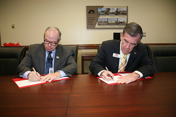 Pete McDonald (left), president of GNTC, and Dr. Mike Holmes (right), senior vice president, chief academic officer, and dean of faculty at GMC sign an articulation agreement at GNTC’s Floyd County Campus in Rome.