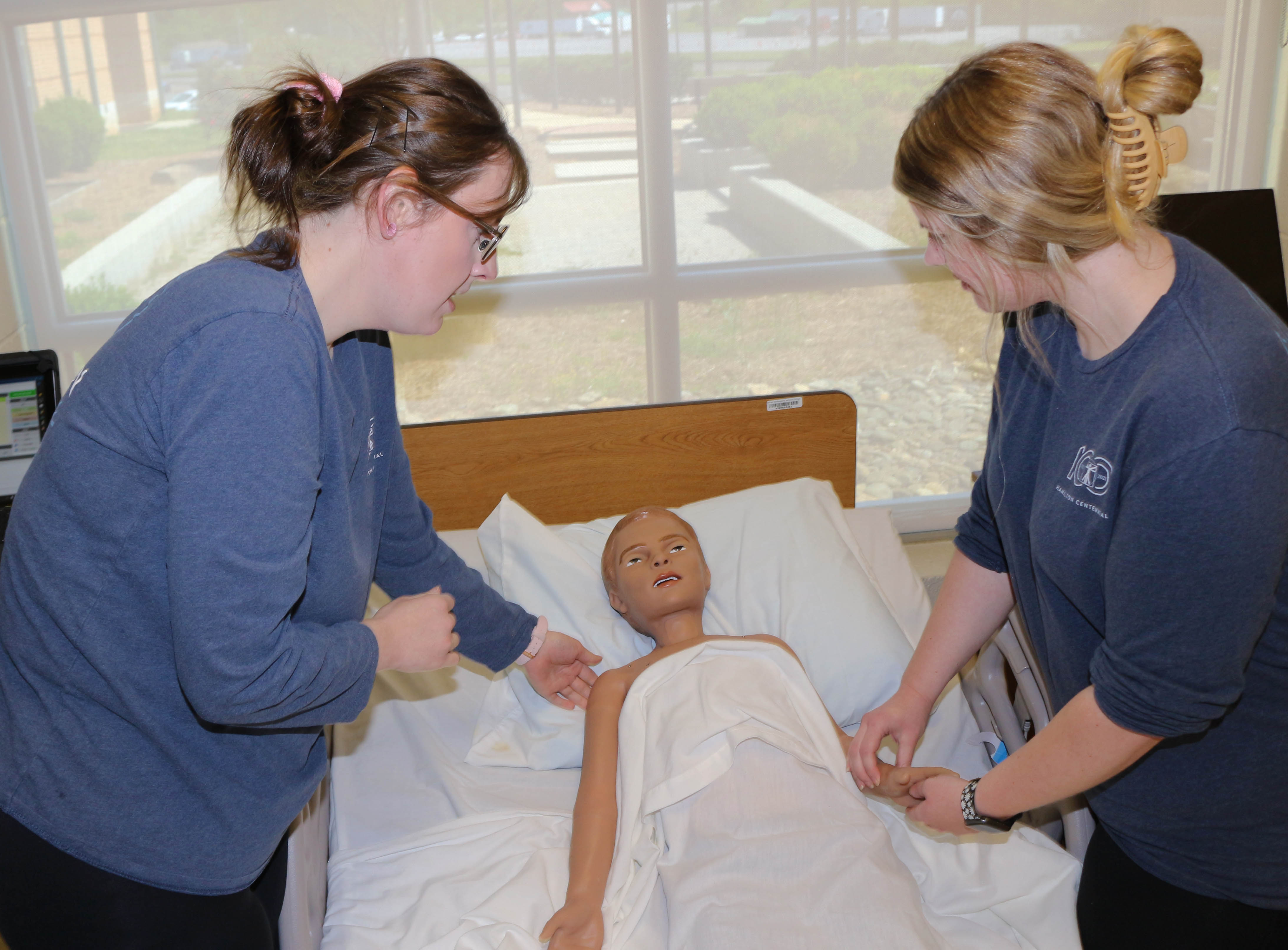 Practical Nursing students Jacob Jackson (left) and Abbie Smith treat a manikin of a young boy as he simulates a seizure. Both students attend GNTC’s Floyd County Campus.