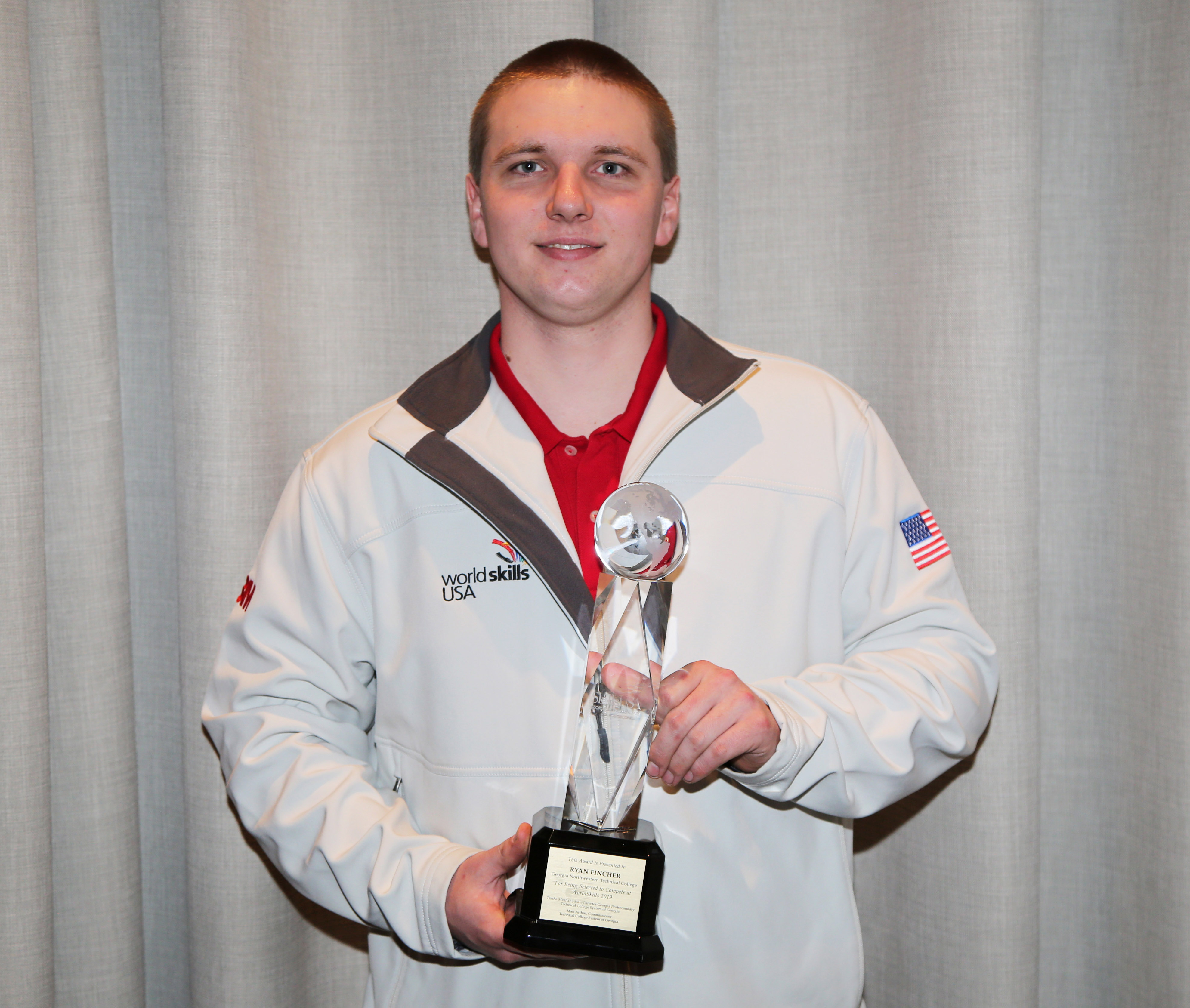 GNTC alumnus Ryan Fincher of Cedartown poses for a picture with the trophy awarded to him at a special presentation during the opening ceremony for SkillsUSA Georgia in March. Fincher was recognized for being selected as the SkillsUSA World Team Welder to represent the county at the WorldSkills Welding Competition in Kazan, Russia.