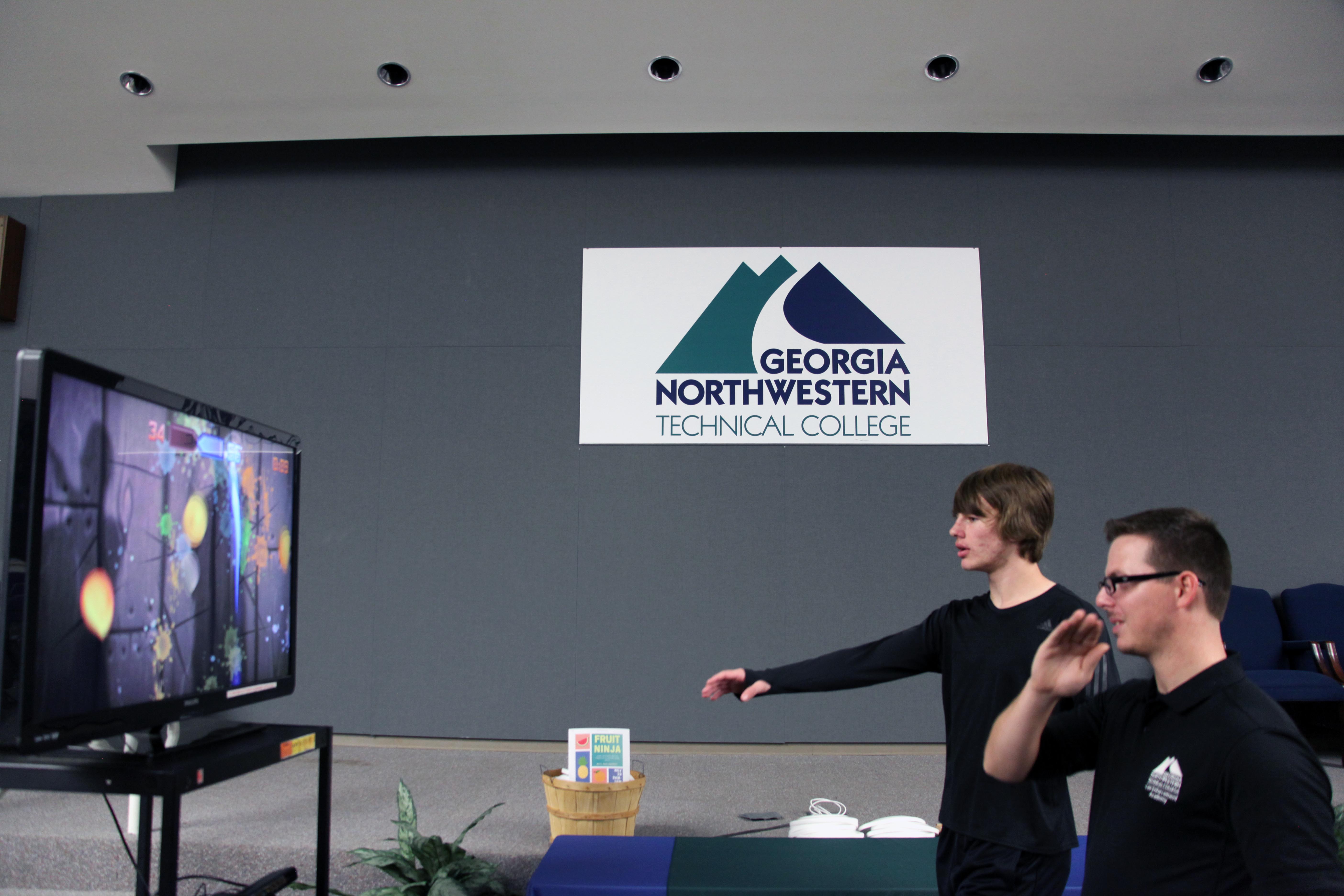 GNTC students Thomas Roberts (front) and Jacob Worthington take time out of their classes to go head to head in a game of Fruit Ninja before the monthly GNTC Student Government Association meeting. 