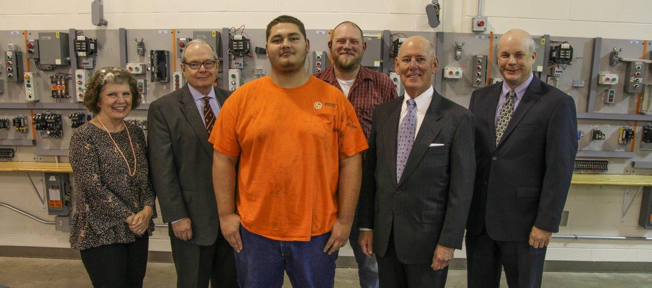 Joshua Dunagan, one of three Manufacturers Education Foundation Scholarship winners at Georgia Northwestern Technical College, poses for a picture with administrators. Shown inside a Georgia Northwestern Technical College Lab on the Whitfield Murray Campus are, from left, Andrea Harper, Georgia Association of Manufacturers Director of Workforce Development; Pete McDonald, Georgia Northwestern Technical College President; Dunagan; Scottie Spears, Georgia Northwestern Technical College Director of Industrial Systems Technology; Roy Bowen, Georgia Association of Manufacturers President; and Brian Cooksey, Shaw Industries Director of Operations Training and Development.