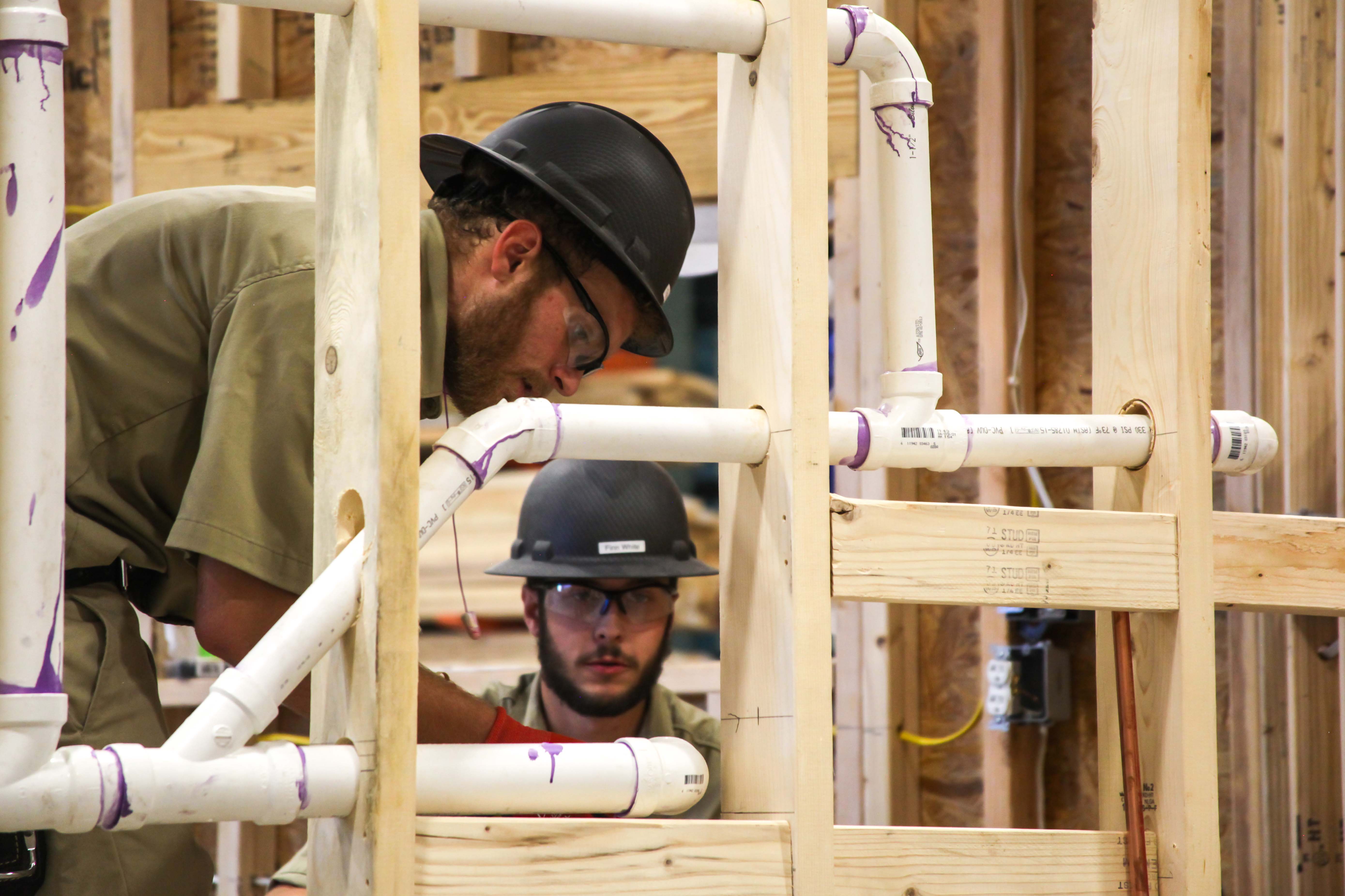 GNTC student Trey Posey (left) works alongside teammate Finn White during the TeamWorks competition for the SkillsUSA National Leadership and Skills Conference earlier this month. The event challenged the team’s carpentry, masonry, plumbing and electrical abilities.
