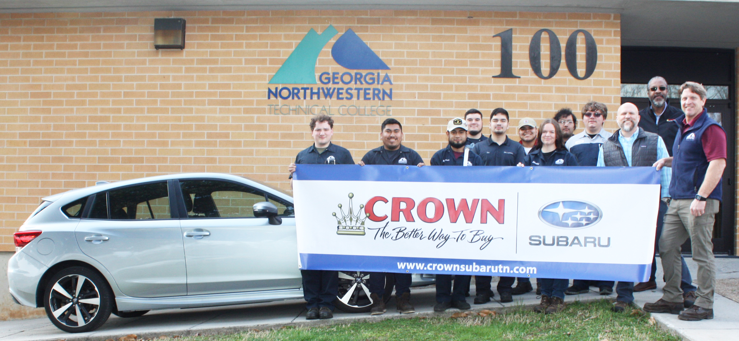 GNTC Automotive Technology instructor Troy Peco (far right) and his students on the Walker County Campus pose with a banner to thank Subaru representatives for the donation of a 2019 Subaru Impreza. From left are students Isaiah Lewis, Isidro Tapia, Miguel Pardo, Gavyn Peace, Eber Calzada, Alex Leon, Shelby Tapley, Luis Rodriguez and Jason Gonneville; Brent Roberts, district parts/service manager for Subaru of America Inc., and Desmond Hagan, fixed operations director for Crown Subaru in Chattanooga.