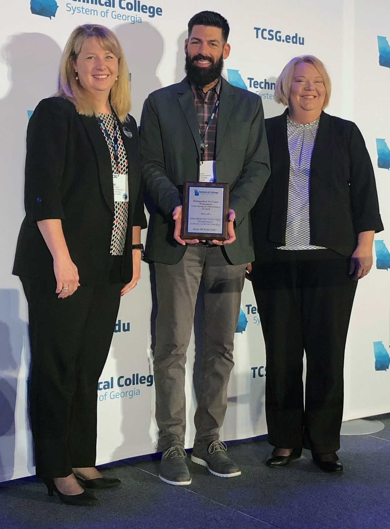 GNTC President Dr. Heidi Popham (from left) stands with Chad Mutchler, Adult Educator instructor; and Lisa Shaw, vice president of Adult Education after the Adult Education program was awarded the TCSG Distinguished Test Center Performance Award.