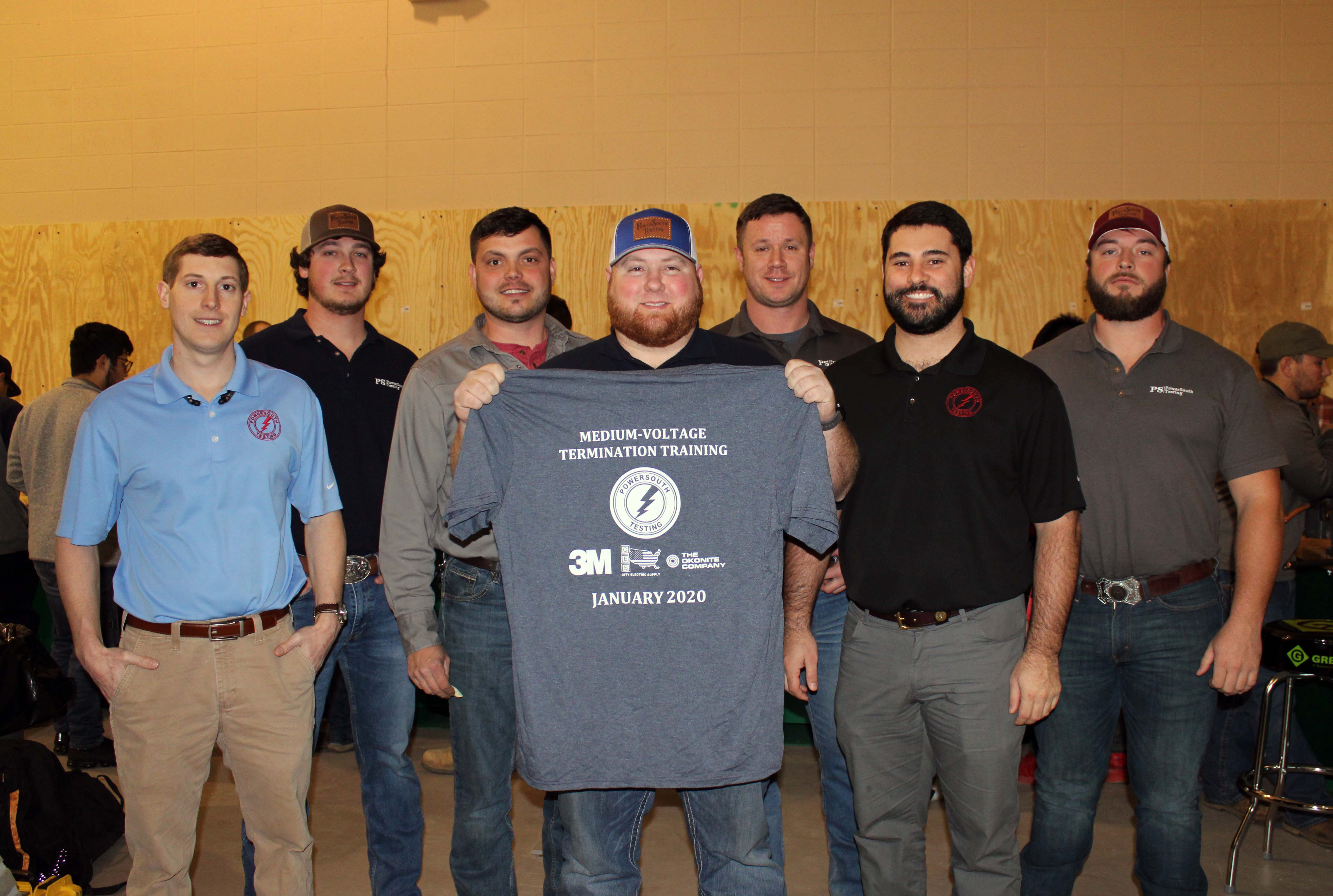 The PowerSouth Testing Team pose with the medium-voltage termination training shirt which was given to GNTC Electrical Systems Technology students after they completed six-hours of training. From left, Samuel Townsend, Logan Thomas, Billie Patnode, Layne Griffith, Colby Lackey, Lee Couth and Dreu Sams.