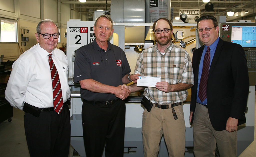 (From left to right) Pete McDonald, president of GNTC; David Aycock, Haas specialist; Bart Jenkins, director of the Machine Tool Technology program at GNTC; and Jason Gamel, director of the Foundation at GNTC stand in front of a Haas Computer Numerical Control (CNC) machine in the Machine Tool Technology lab on the Floyd County Campus. Aycock presented a grant of $7,500 to Jenkins to be used for student scholarships.