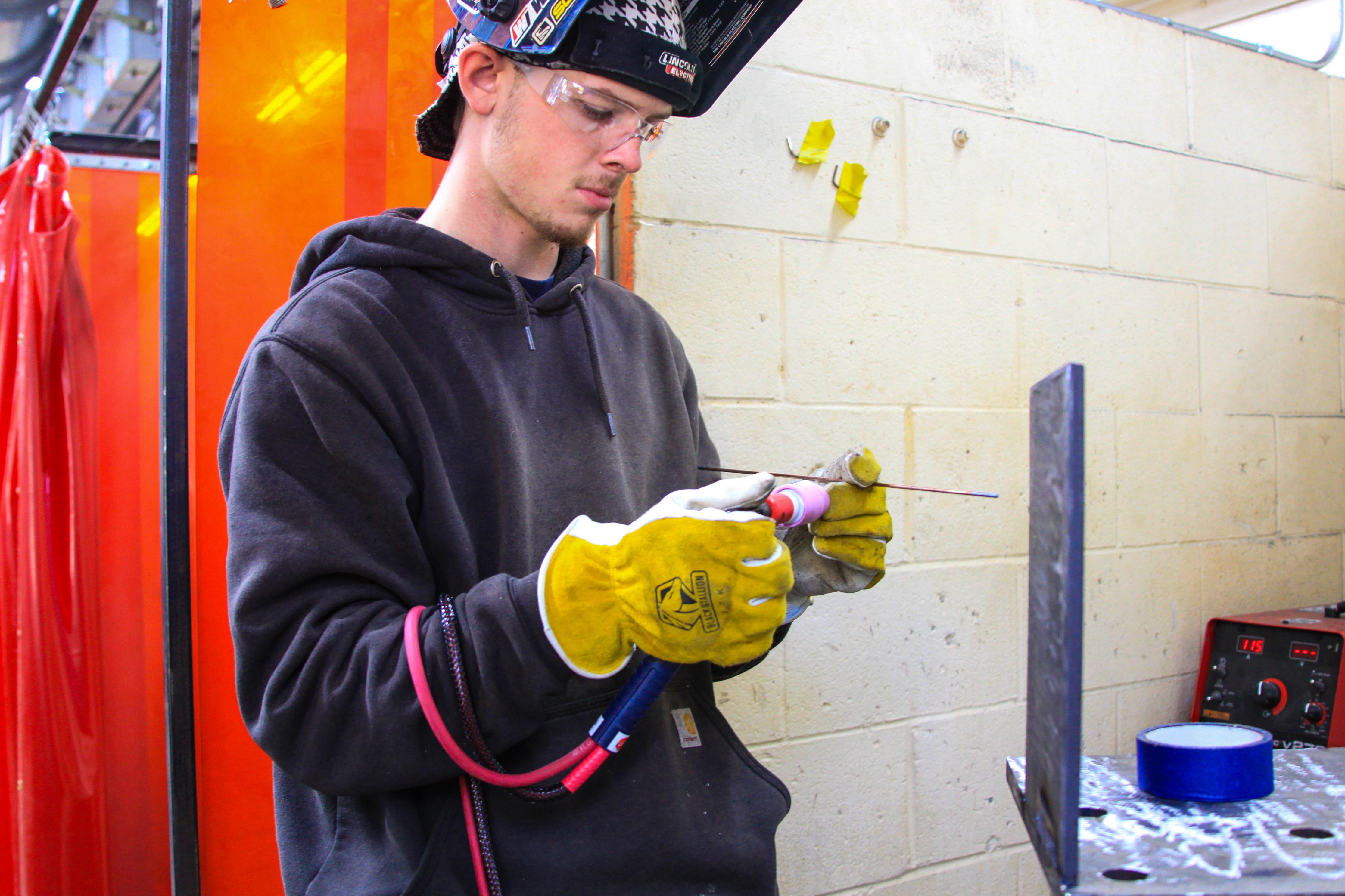 GNTC dual enrollment student Andrew Harrell checks a welding rod before working on a project in the Floyd County Campus Welding lab.   
