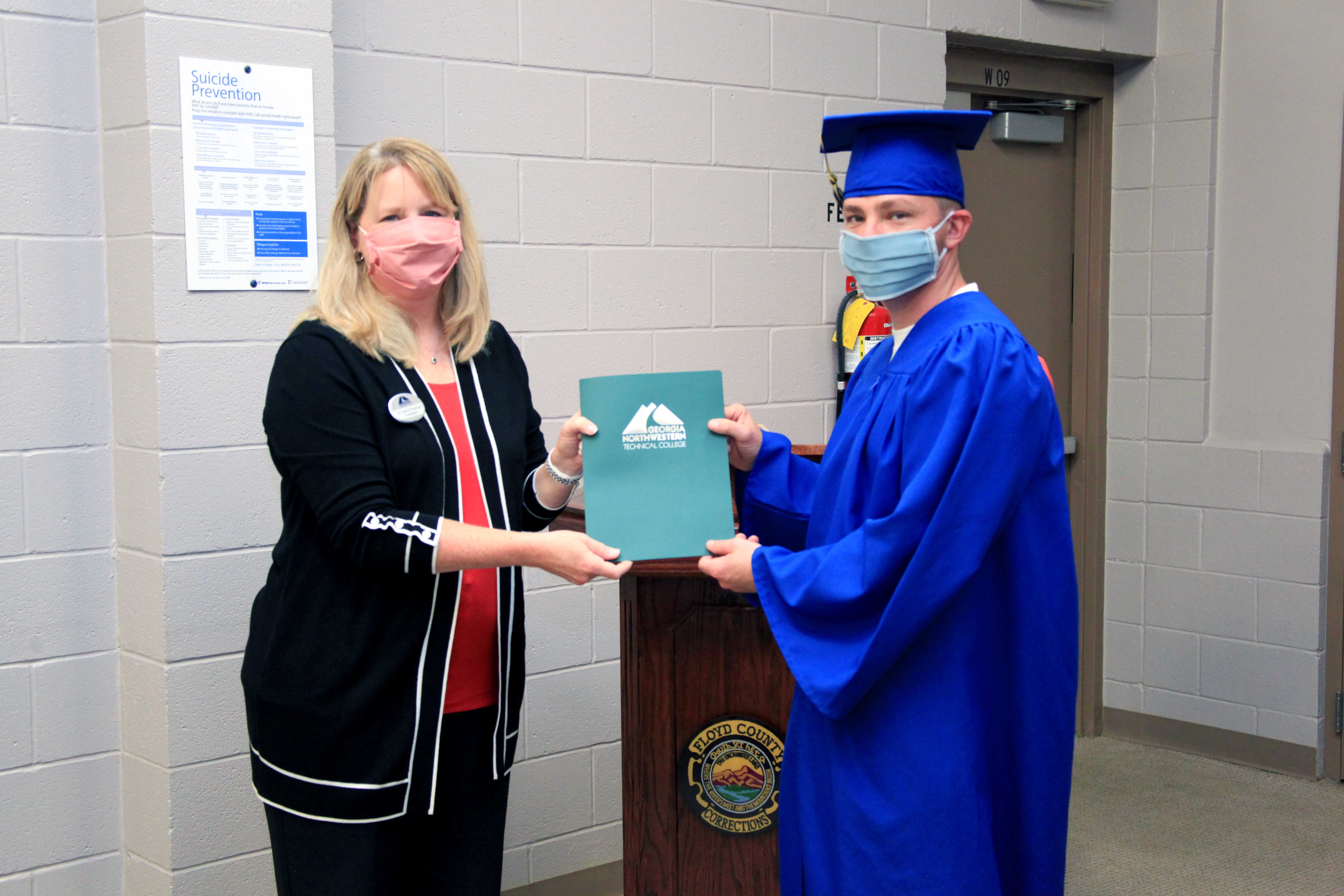 GNTC President Dr. Heidi Popham (left) hands Christopher Brookins his certificate showing he is fully certified in Shield Metal Arc and Flux Core Welding. Brookins and 11 other offenders took a Welding course at the Floyd County Prison sponsored by Georgia Northwestern Technical College. 