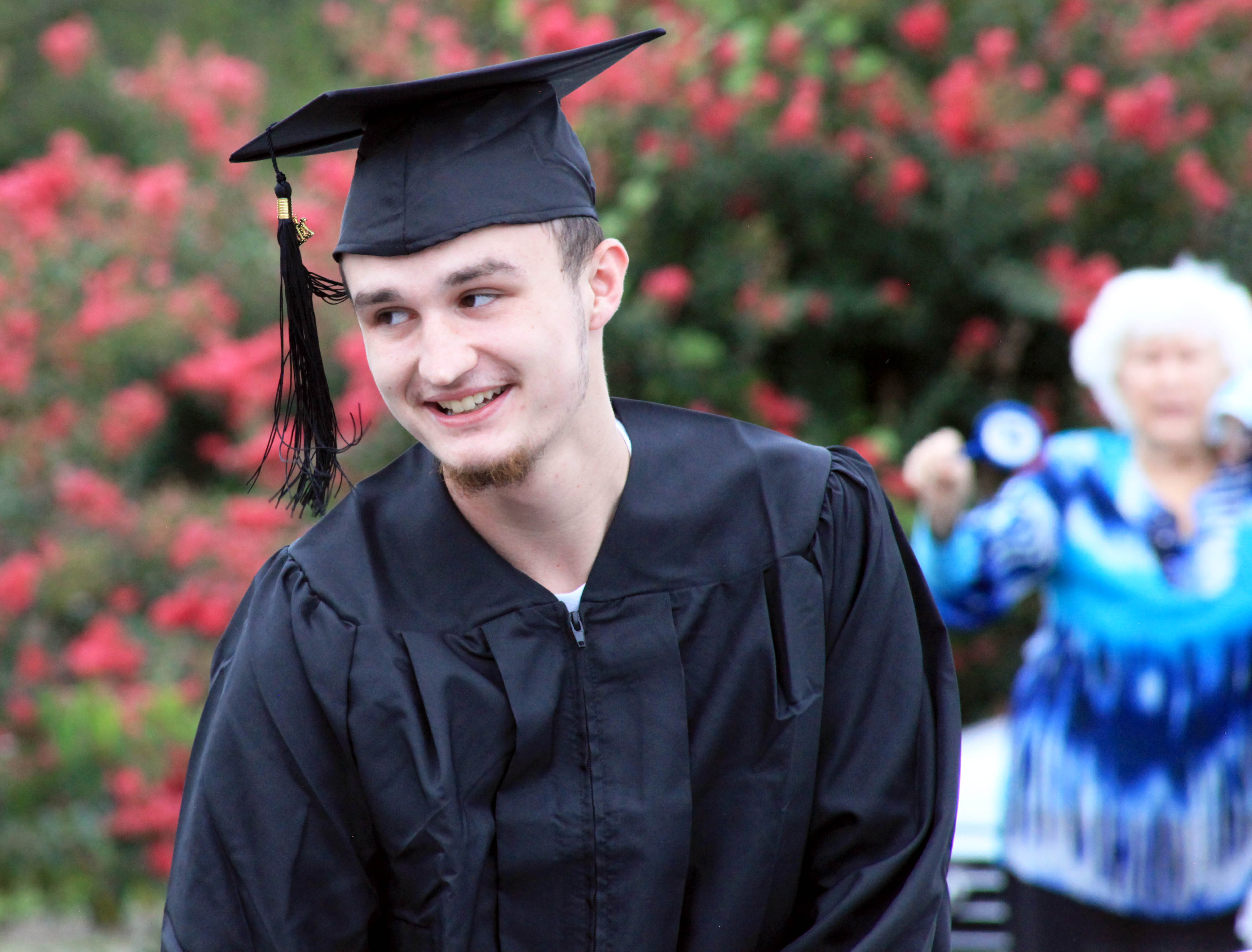 Dawson Cobb of LaFayette gets out of his car to receive his GED® diploma during the Drive-In Graduation at GNTC’s Walker County Campus on Tuesday, Aug. 26. 