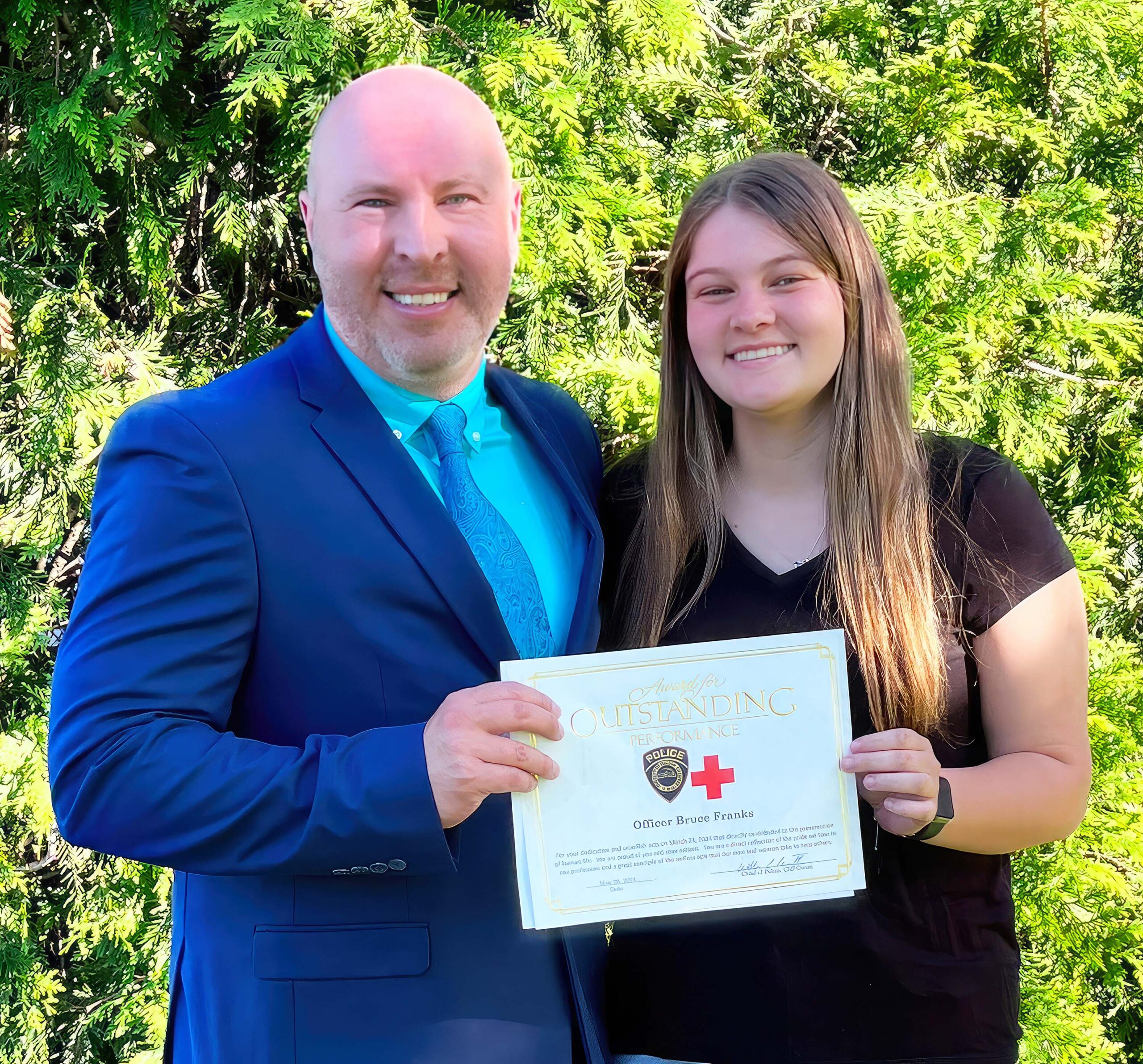 Liberty Franks (right) congratulates her father, GNTC Police Sgt. Bruce Franks, upon his receipt of the Dalton Police Department’s Life Saving Award.